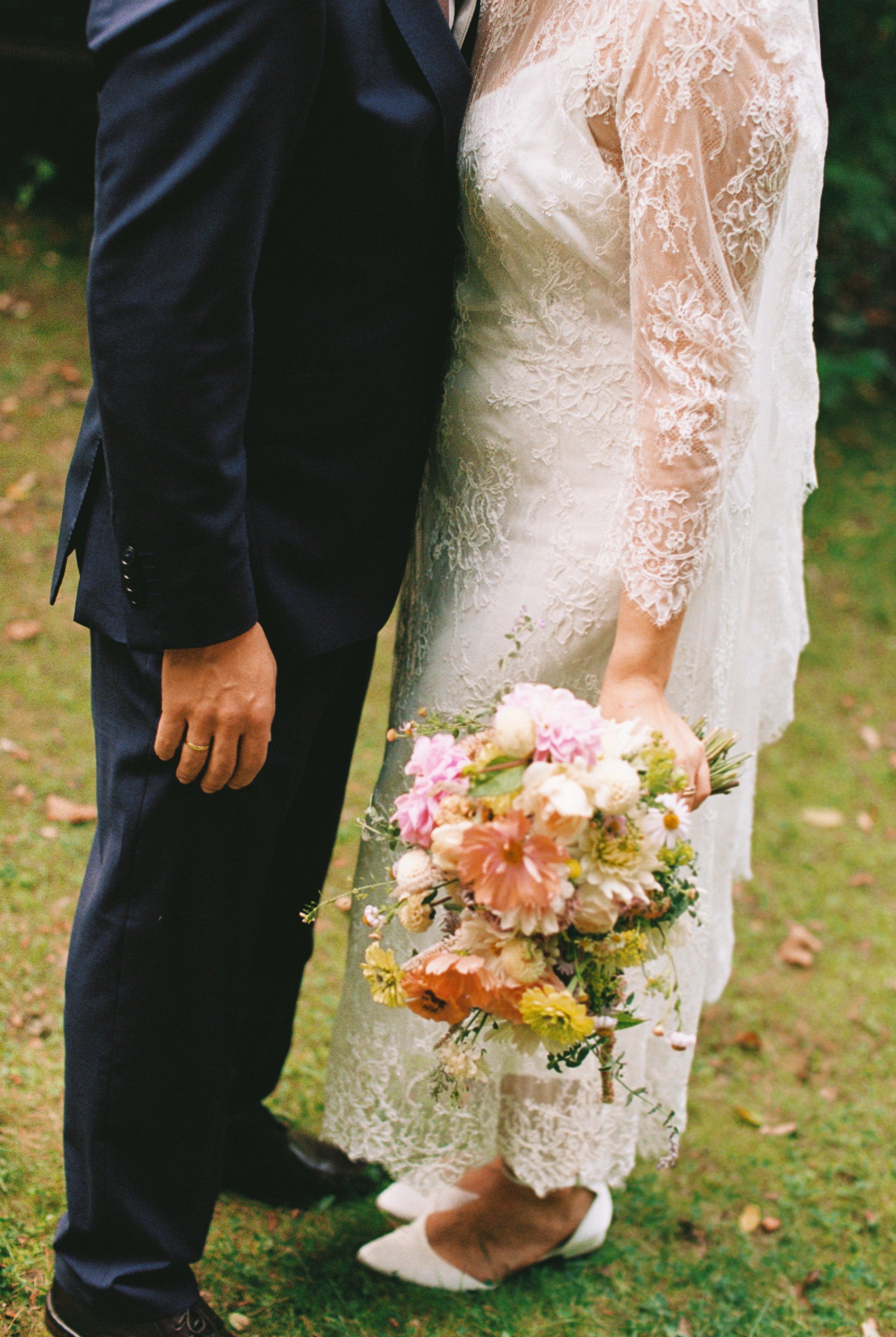 Bride and groom standing in a lawn for their Hochzeitsvilla wedding