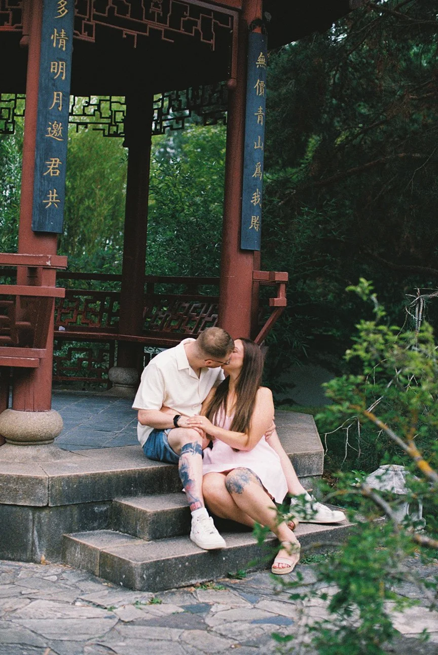 Analogue photo of a couple kissing in Garden of the World in Berlin.