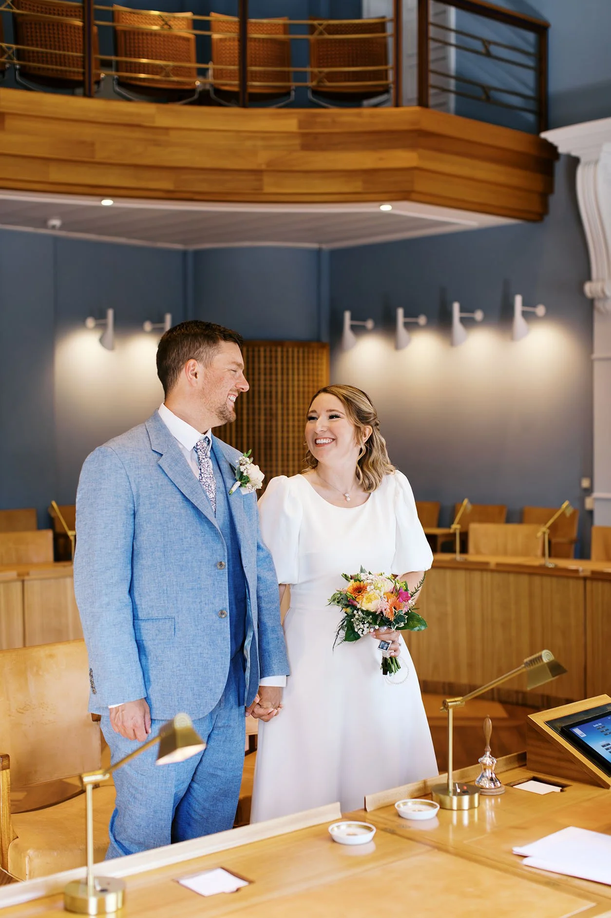 Wedding couple getting married and smiling at each other at Kolding Town Hall in Denmark.
