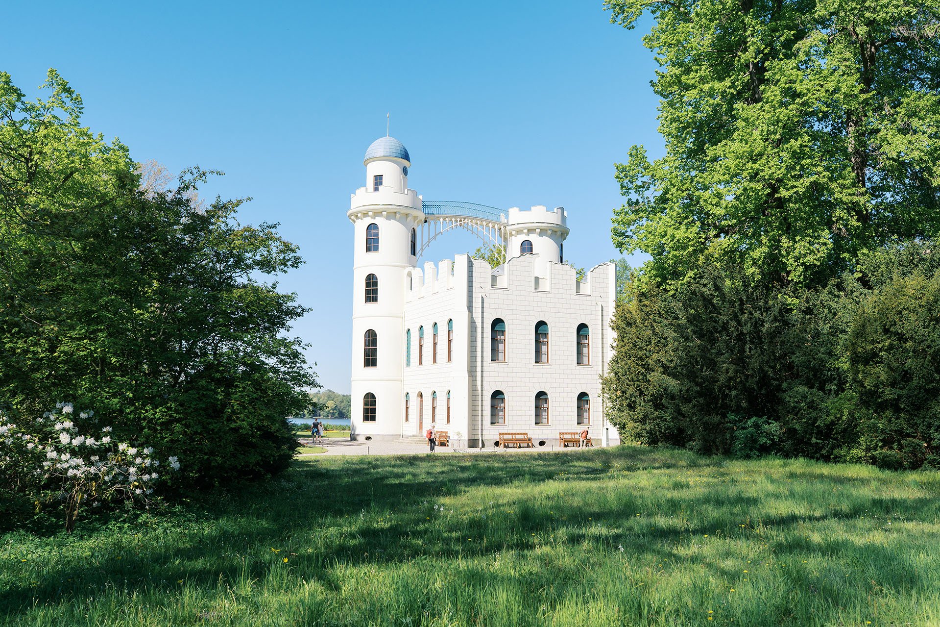 Schloss Pfaueninsel, Castle of Peacock Island framed by beautiful tress and skyline.