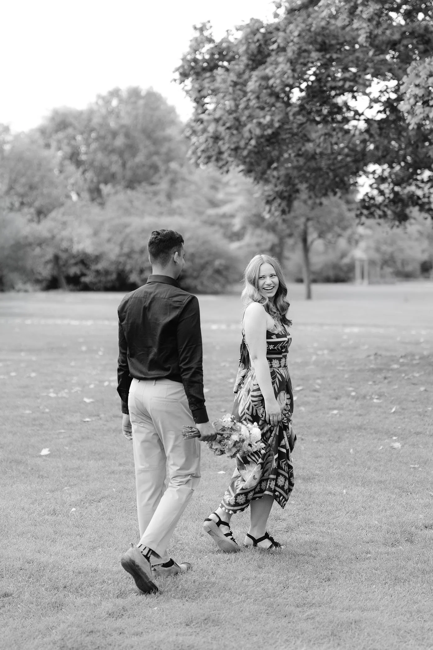 Candid, documentary photo of couple celebrating their engagement in a park, Berlin.