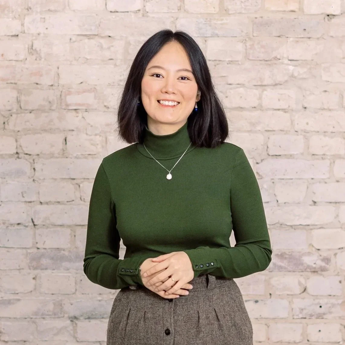 Berlin based photographer, Duo Chen, smiling in a green top