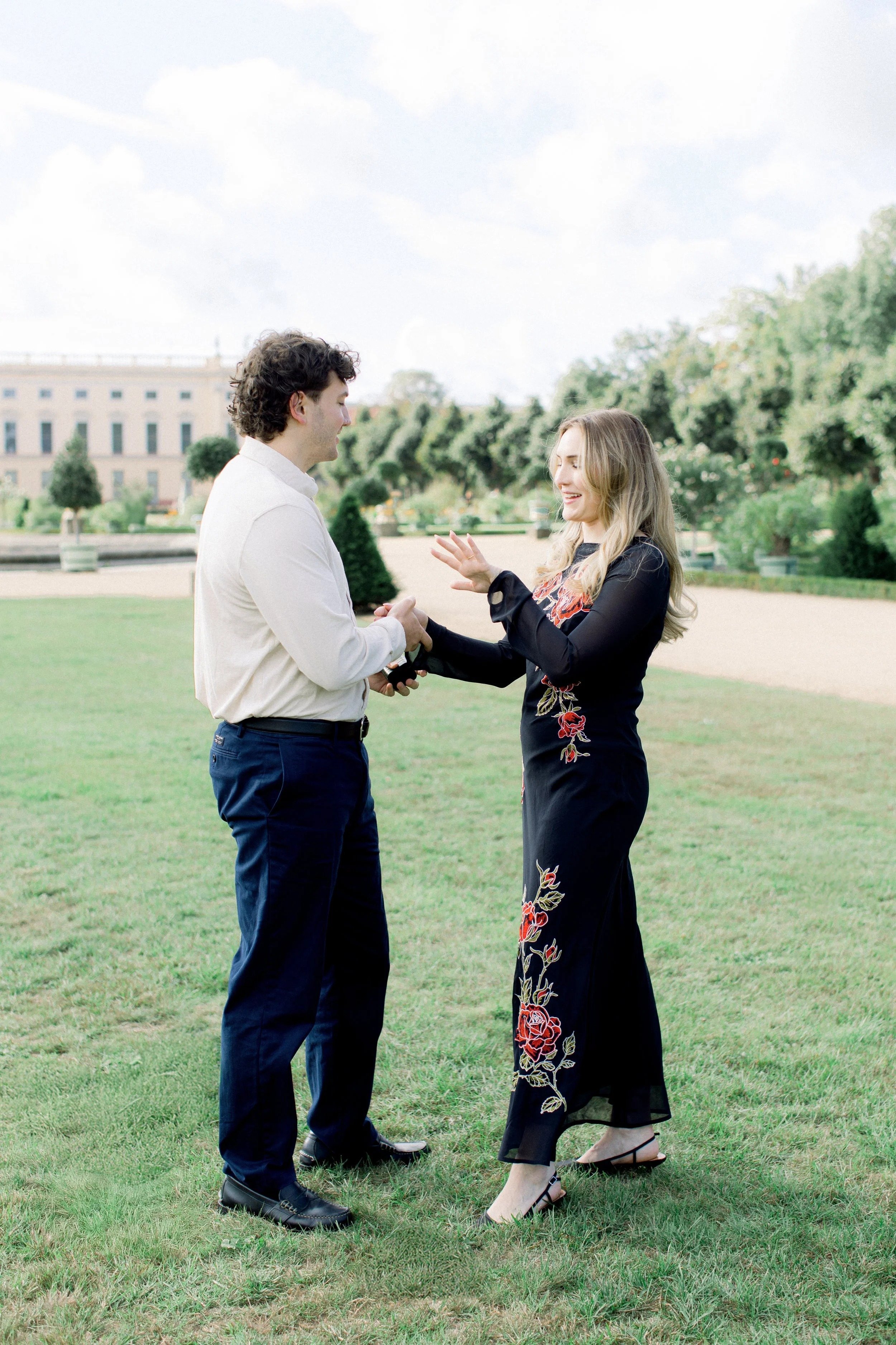 A couple celebrate their fresh engagement in Berlin, the girl is looking at her engagement ring.