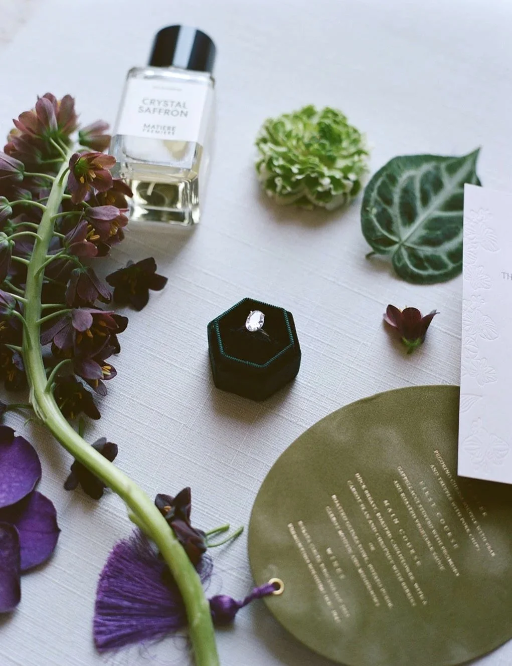 Detailed shots of flat lay wedding photography with a diamond ring in the centre.