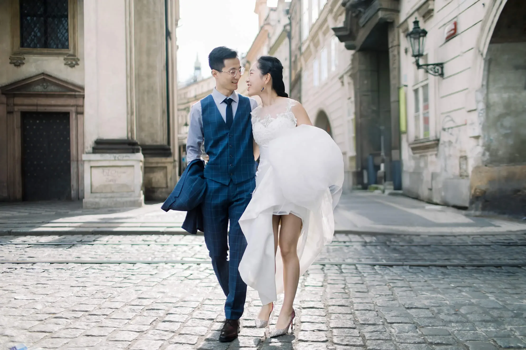 a couple in wedding attire walking across the street in Berlin, Germany