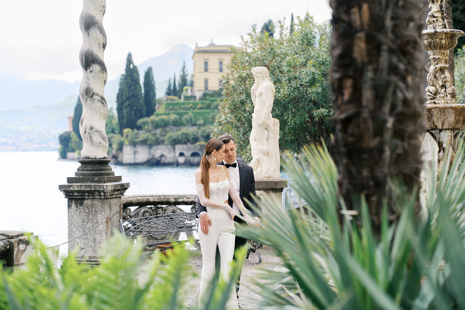 A wedding couple embracing each other for their portrait photos at Villa Monastero Garden, Itay, captured by Duo Chen Photography.