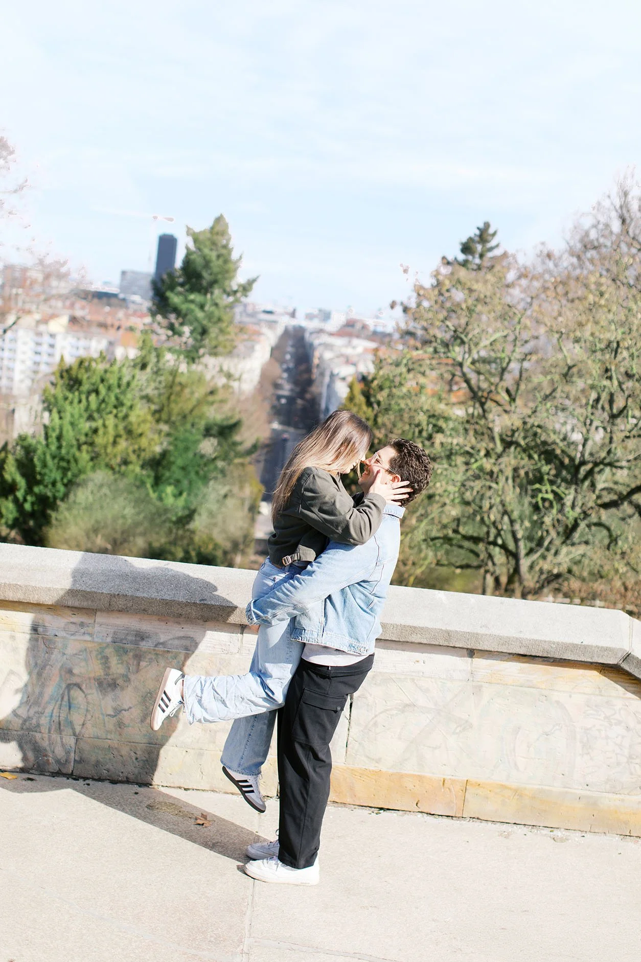 A couple hug each other and celebrate their fresh engagement at Viktoriapark in Berlin,