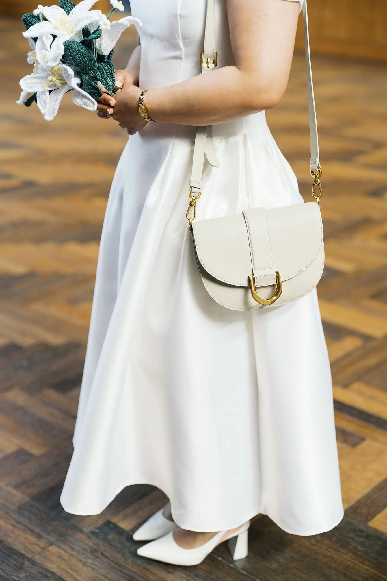 Detail shot of a bridal dress and a matching purse.