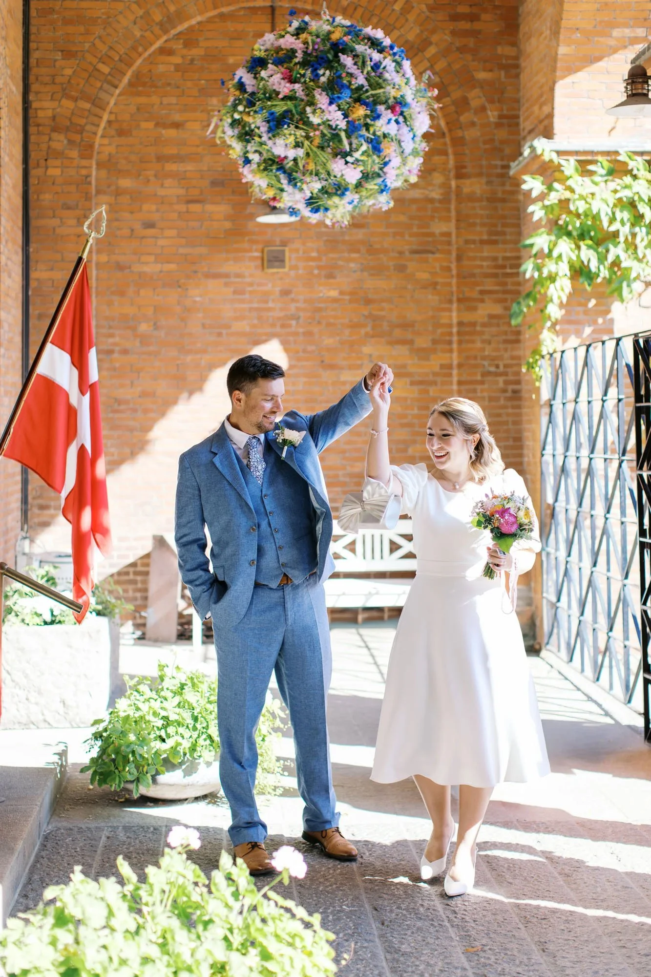 Couple dancing with the Danish flag taken by wedding photographer in Berlin, Duo Chen Photography