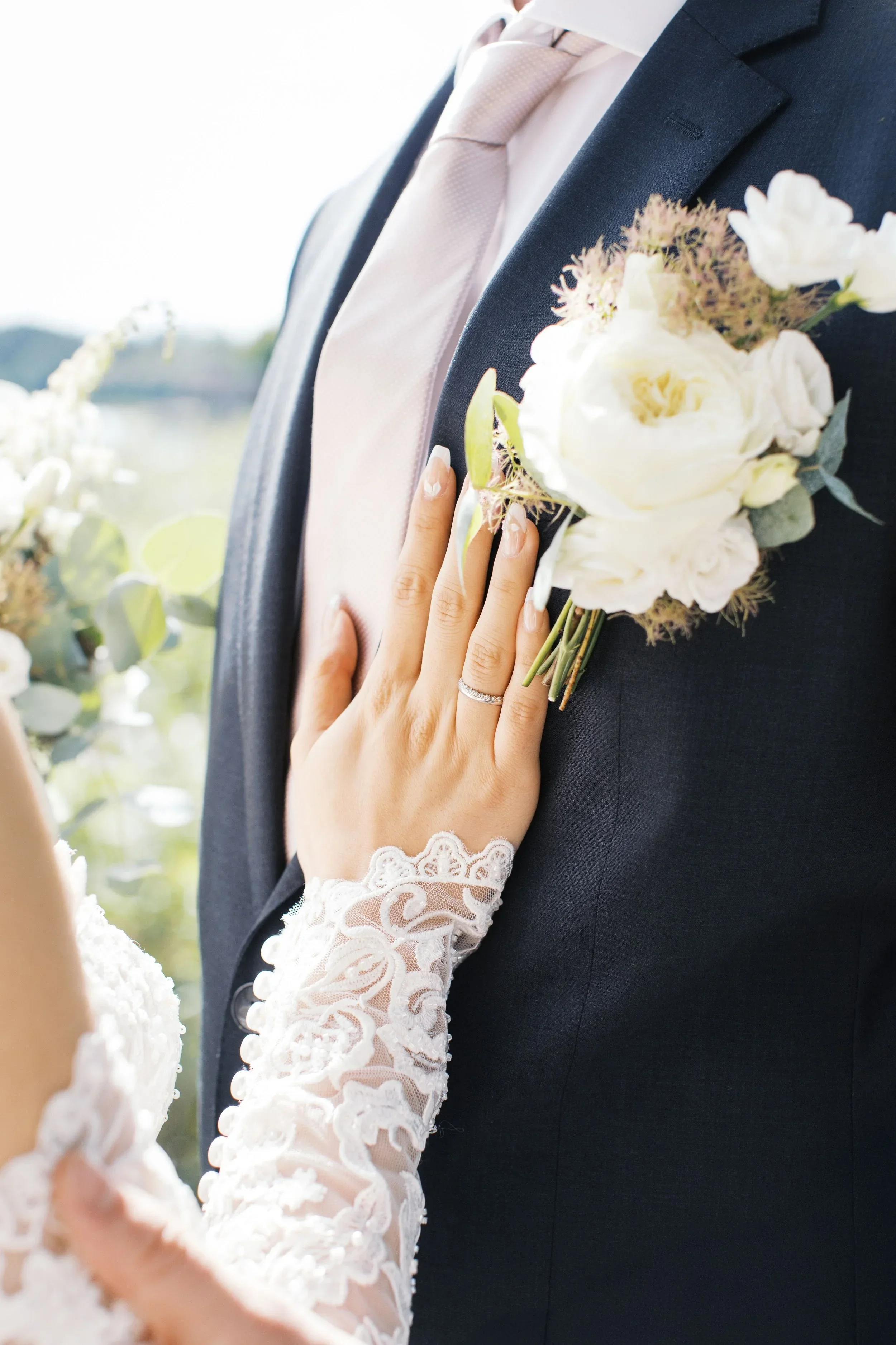 Close up of a bride's hand on groom's check