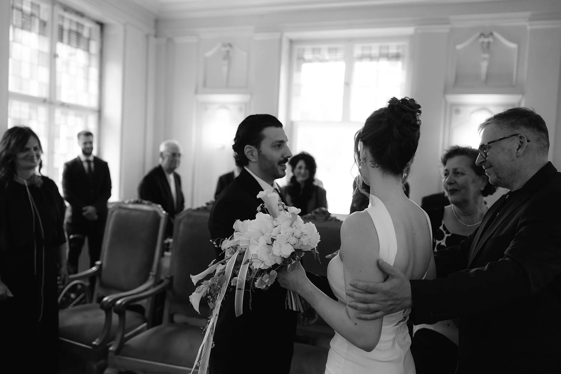 Father sending his daughter away to the groom during a civil wedding in Standesamt Schöneberg in Berlin.