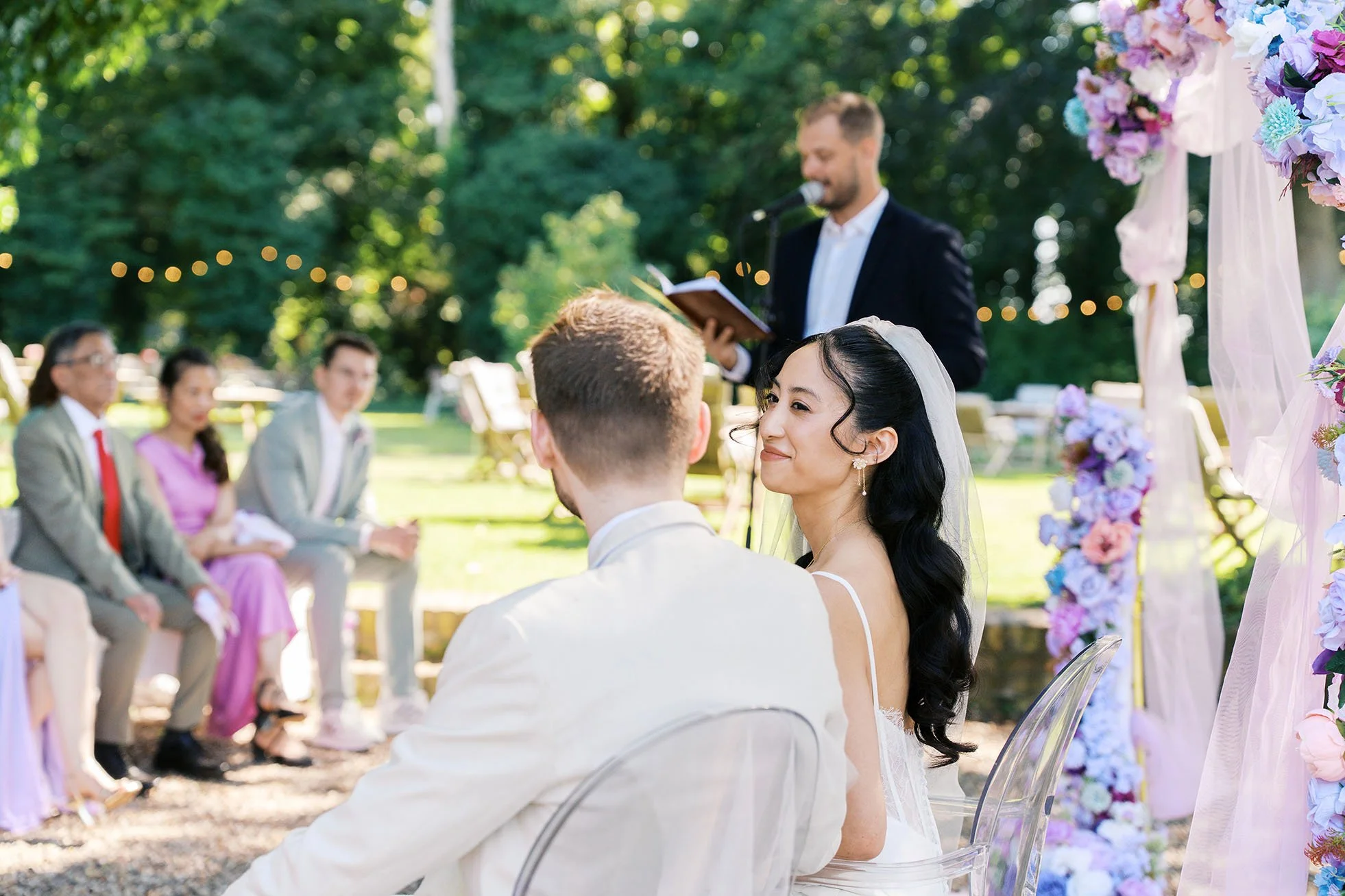 Bride smiling at her husband at a wedding ceremony at Gut Schloss Golm in Potsdam, captured by Duo Chen Photography