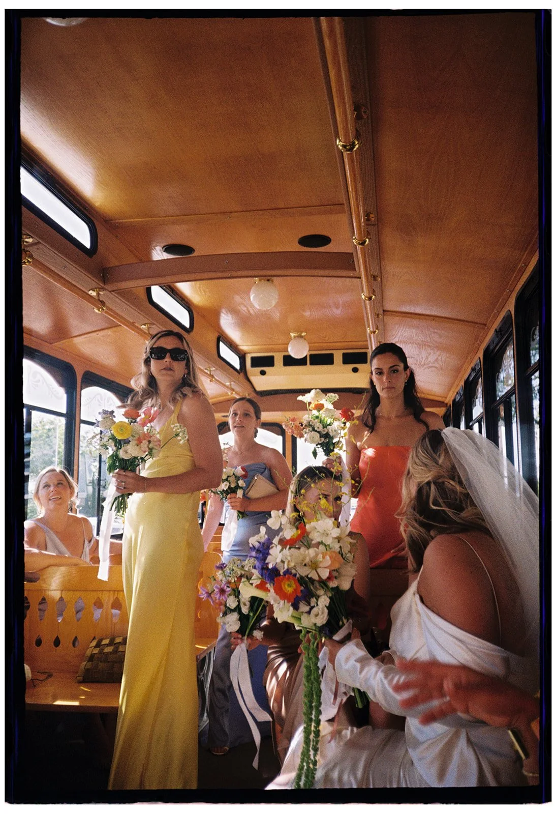 Bridal Party in colorful dresses rides Trolley