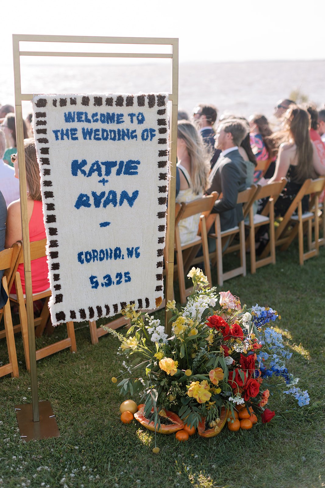 Welcome sign shag rug with floral accent at ceremony