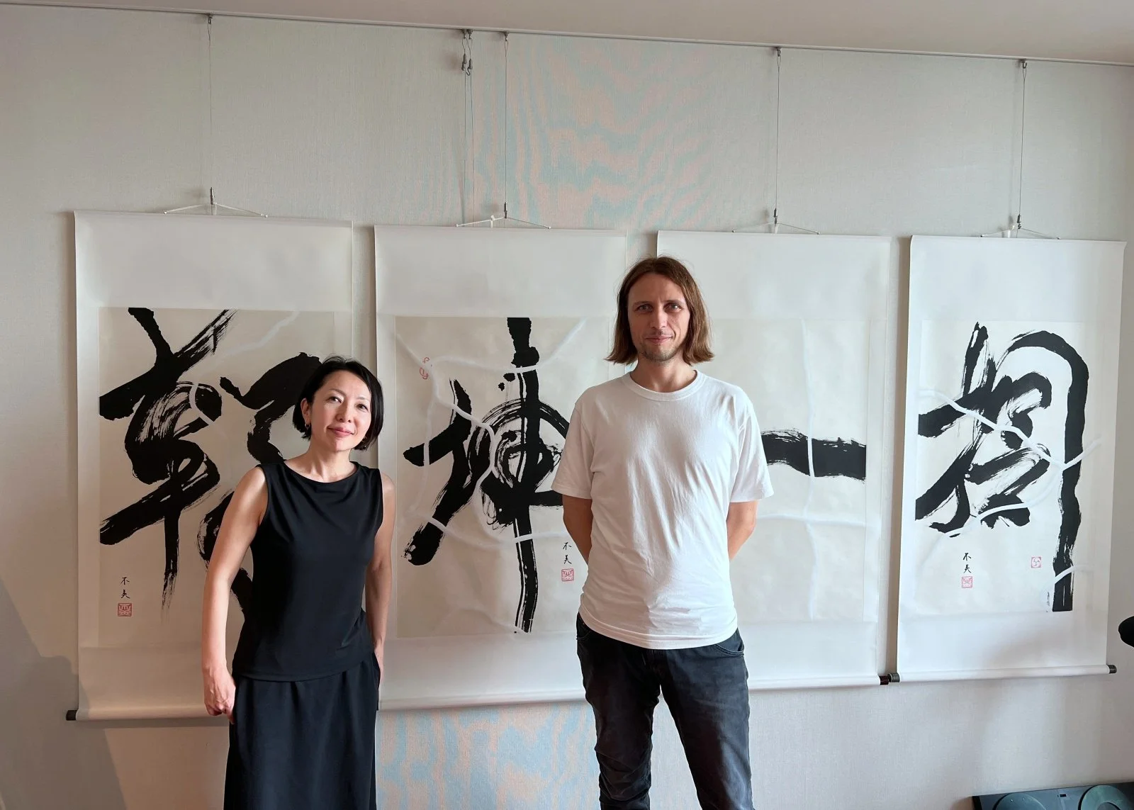  New members Naoko Mikami and Baptiste Tavernier, in front of Naoko's amazing calligraphy 