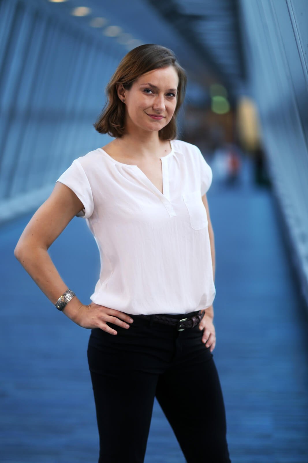 Portrait of Rosie Slater, Co-Founder and Global Director of The Delphi Network, standing in a modern architectural setting, representing international business development between the UK and Japan.
