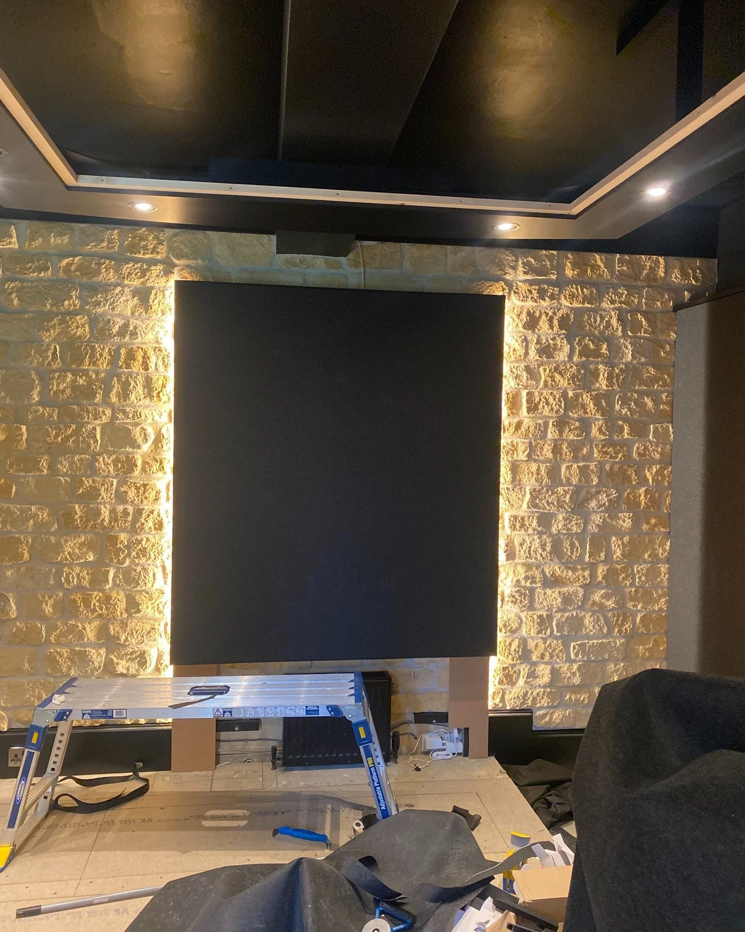 Although this studio space needed some acoustic treatment the character of the stone wall was too important to lose. 
By designing, building and installing this custom-built panel with backlighting we think we've managed to find the right balance.