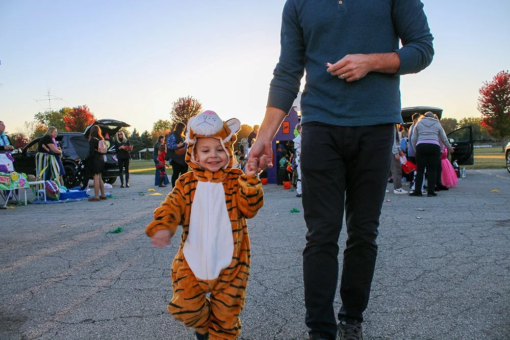 A student in a tiger costume at the Davis Trunk or Treat