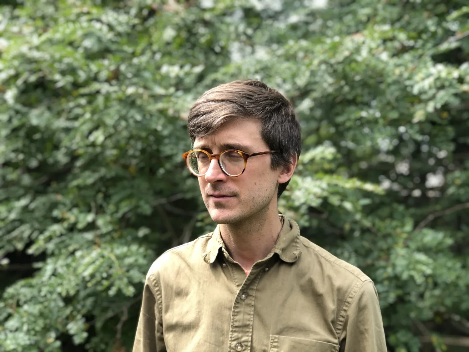 Man standing in front of trees