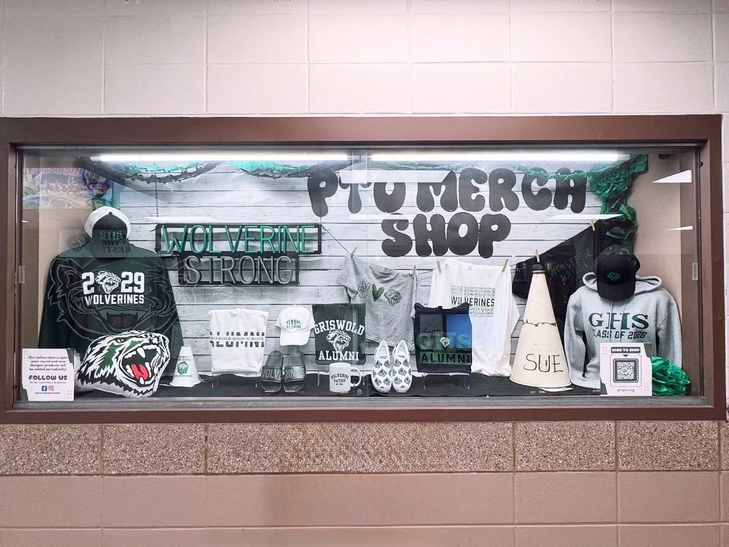 Our PTO Merch Shop window display is stocked and ready! From Class of gear to spiritwear, shoes, mugs, pillows, and hats, we&rsquo;ve got everything you need to show off your Wolverine pride. 🖤💚
.
.
.
#ghspto #ghsptomerchshop #wolverinenation #spir