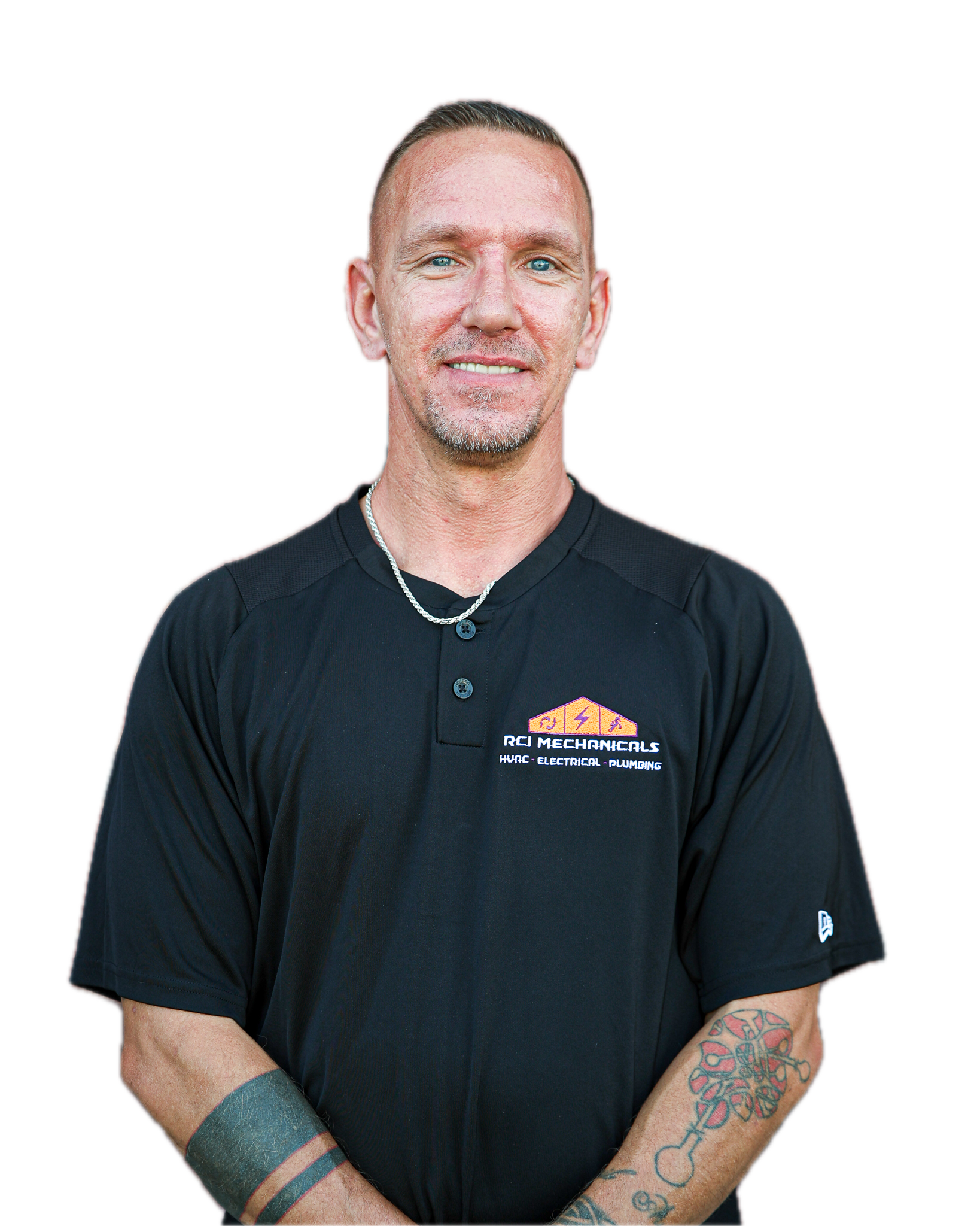 Man with short hair and tattoos on his arms wearing a black company shirt with a logo and text for RCI Mechanical, standing with arms crossed.