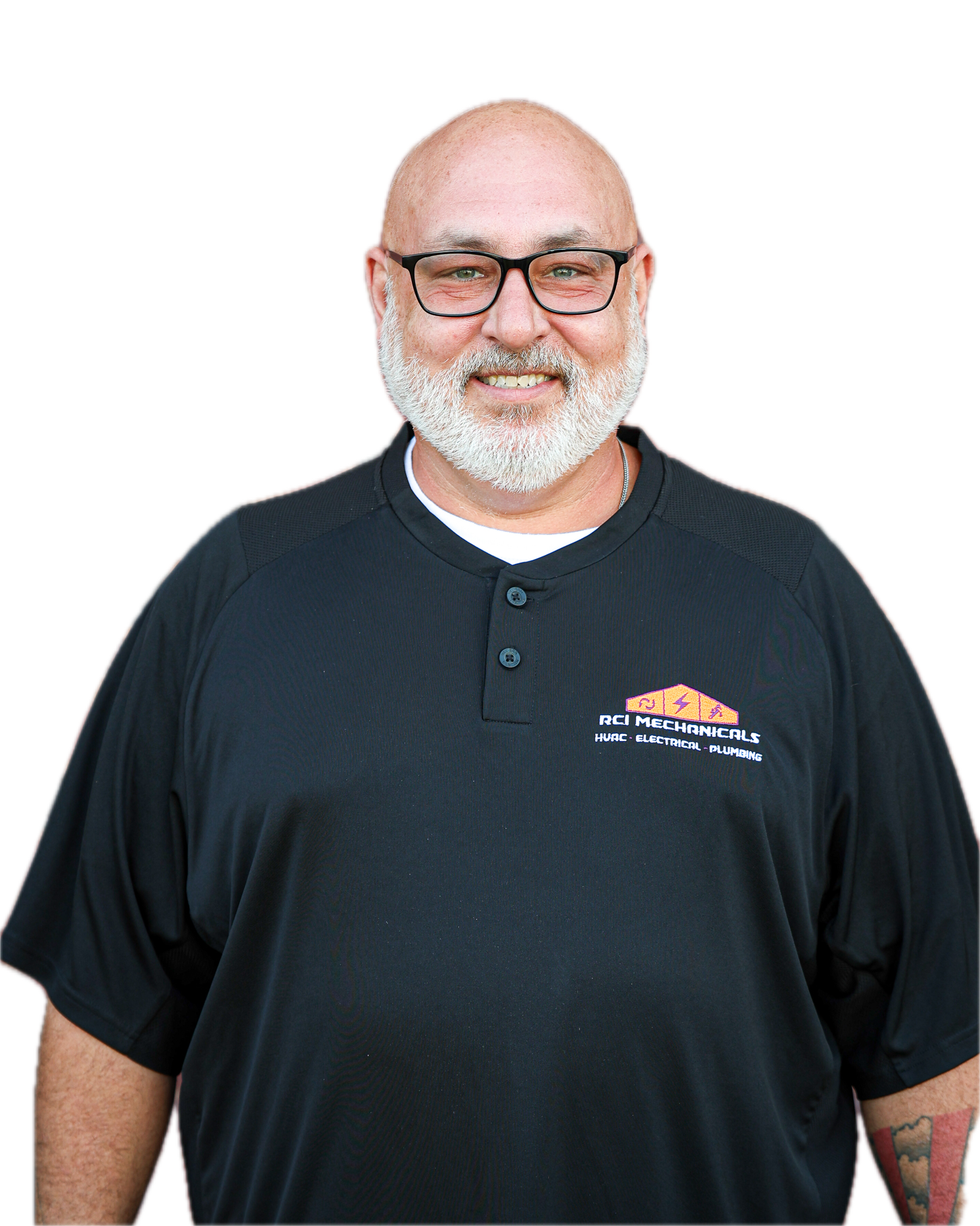 A middle-aged man with a bald head, glasses, and a white beard, smiling and wearing a black shirt with a logo on the chest.