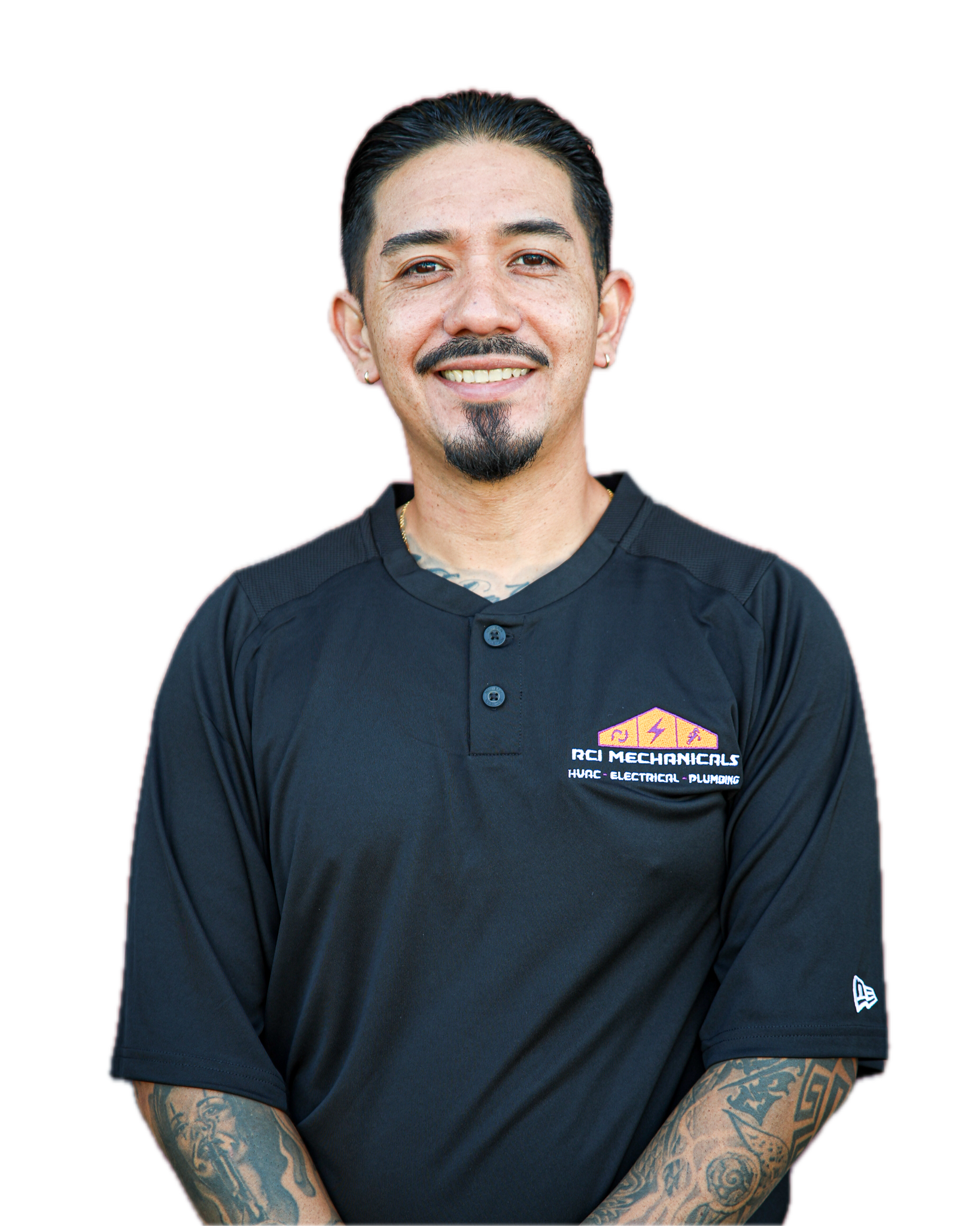 A man with dark hair, facial hair, multiple tattoos on his arms, and earrings, wearing a black shirt with company logo and text, smiling at the camera.
