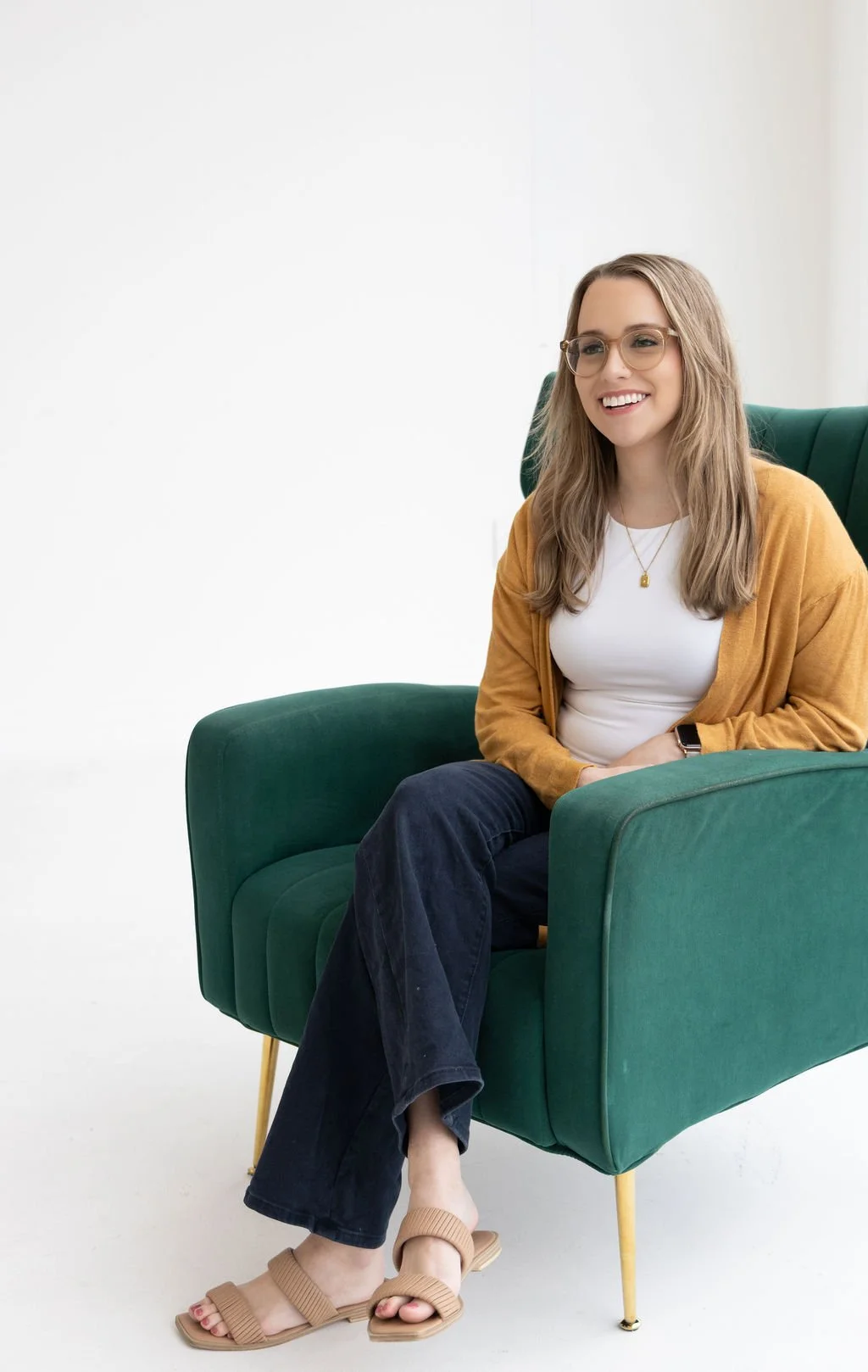 A therapist sits on chair while explaining what is trauma therapy and how does it work.