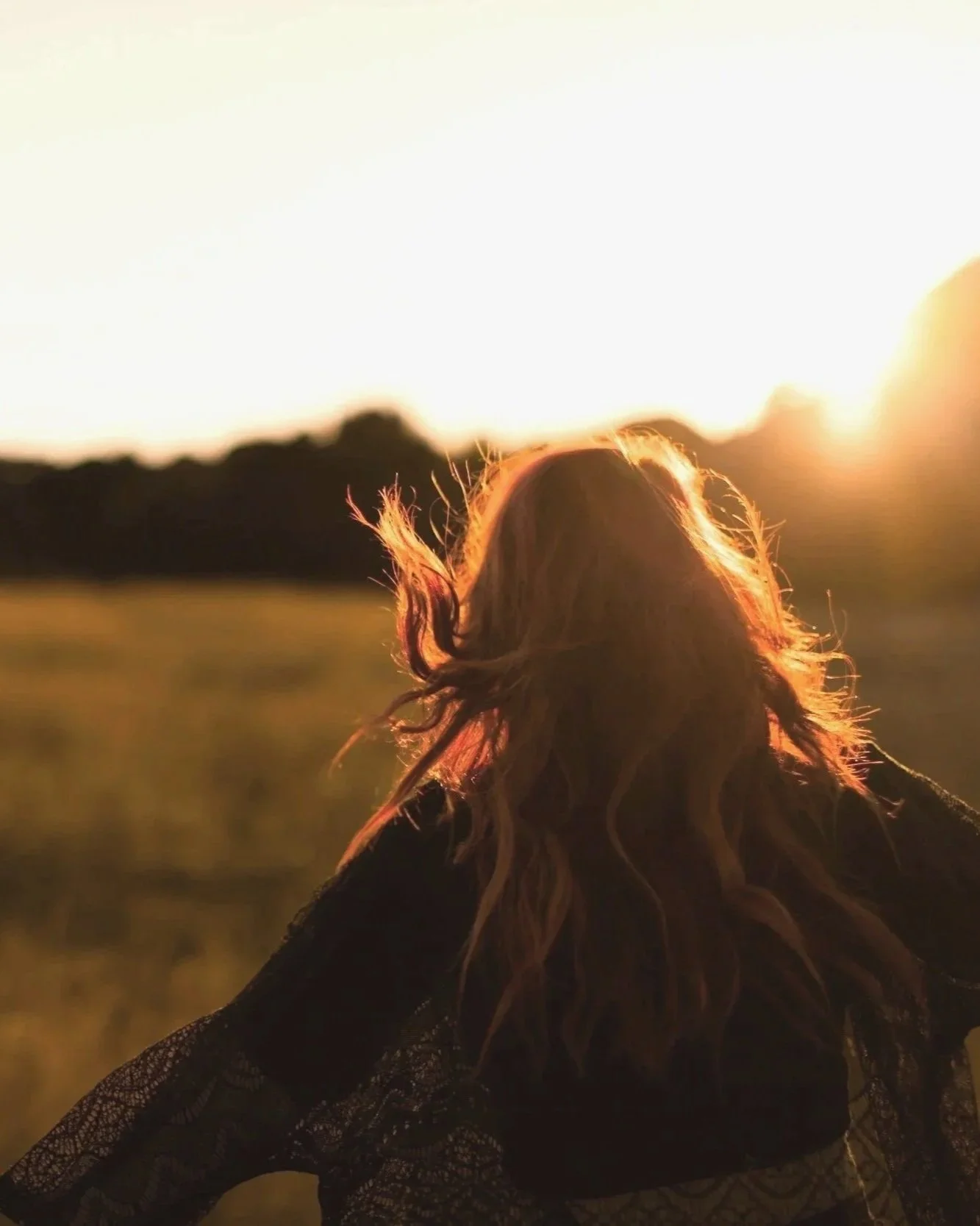 Girl running through a field, feeling free after going to therapy for body image in Plano
