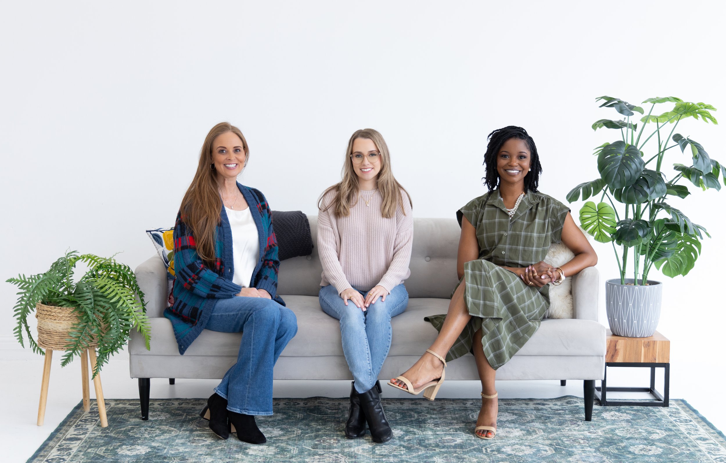 Three Plano therapists who provide affordable counseling smile together while looking ahead.