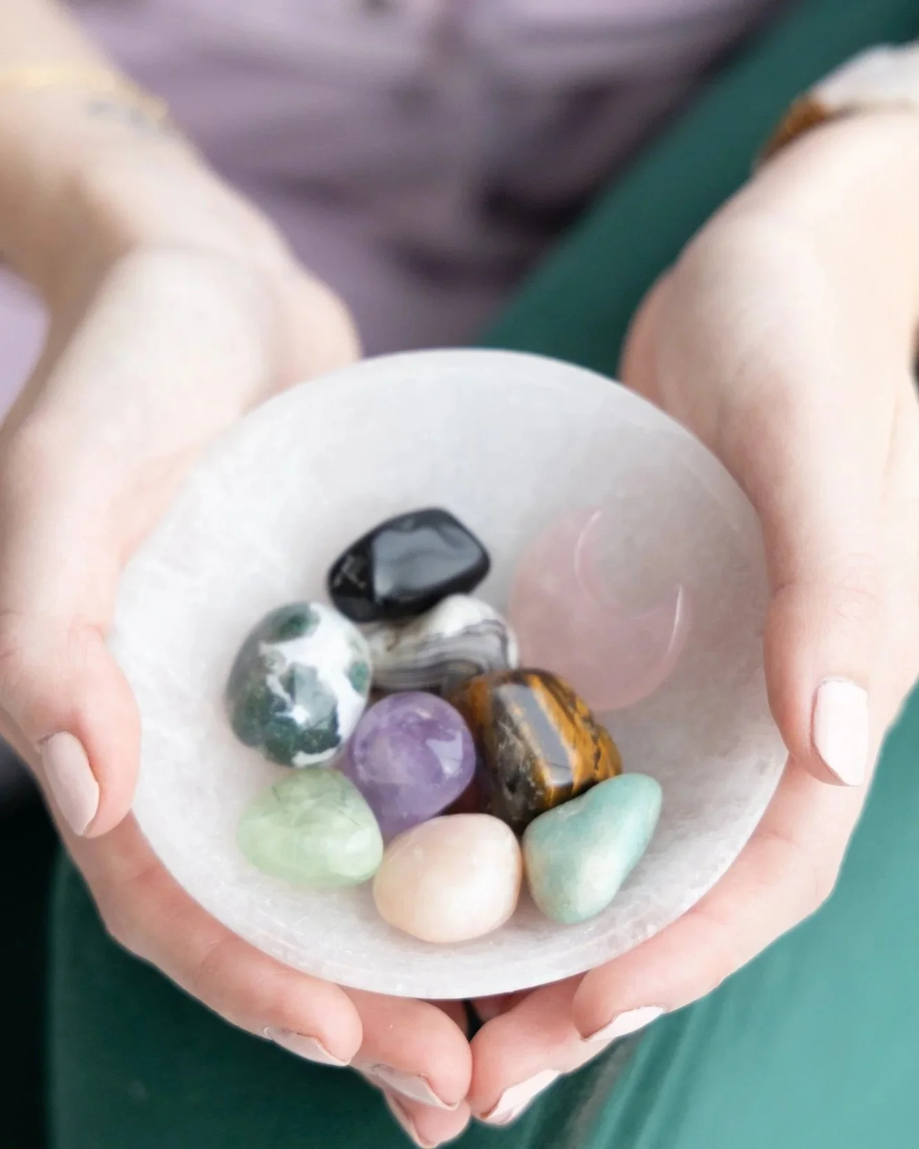 An anxiety therapist in Dallas holds a bowl of crystals.