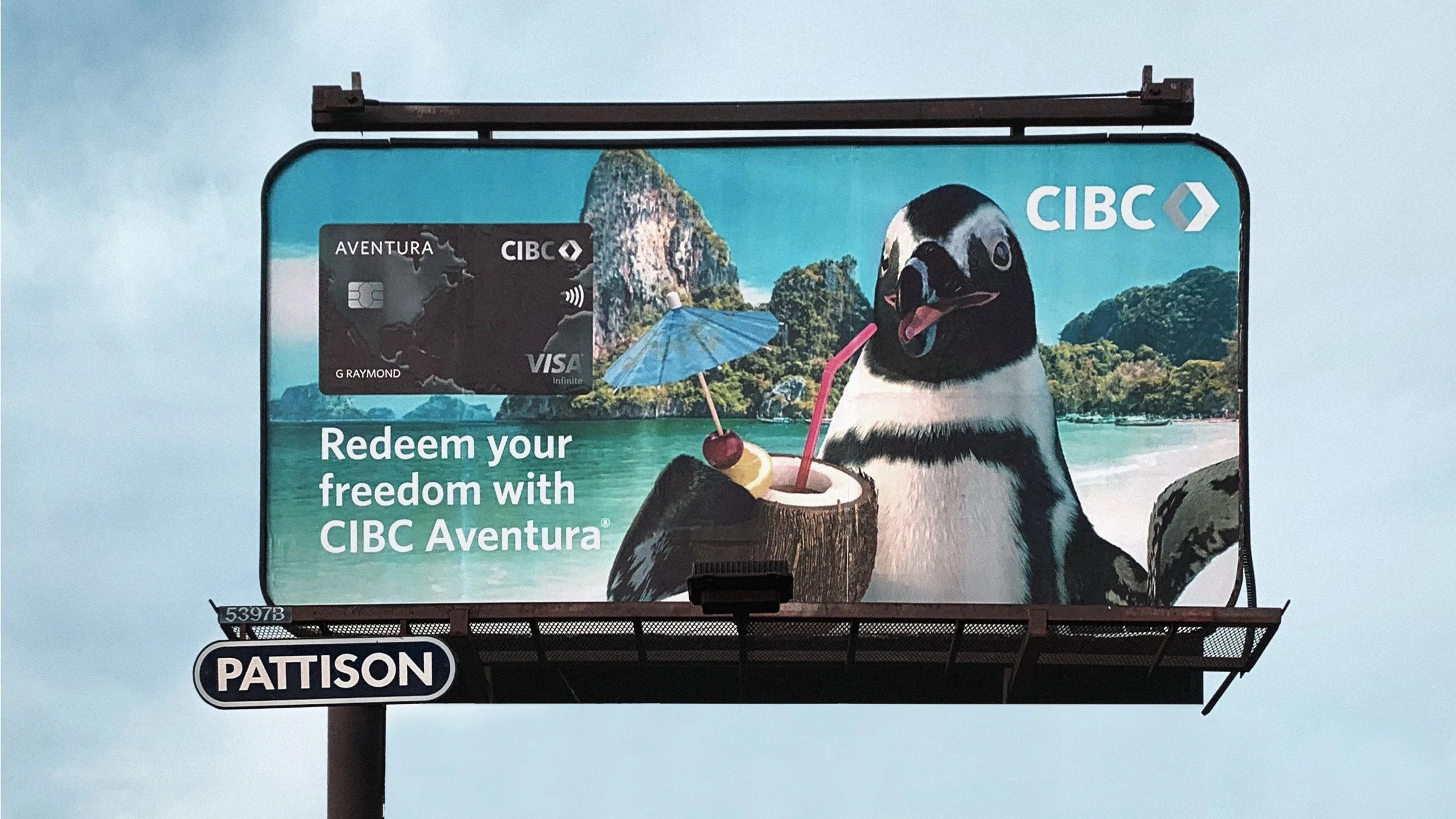 A billboard showing a penguin sipping on a tropical drink.