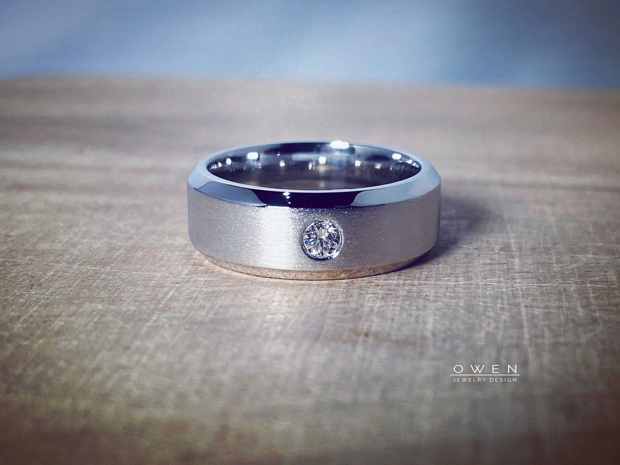 CUSTOM WHITE GOLD BAND WITH A ROUND BRILLIANT CUT DIAMOND.jpg