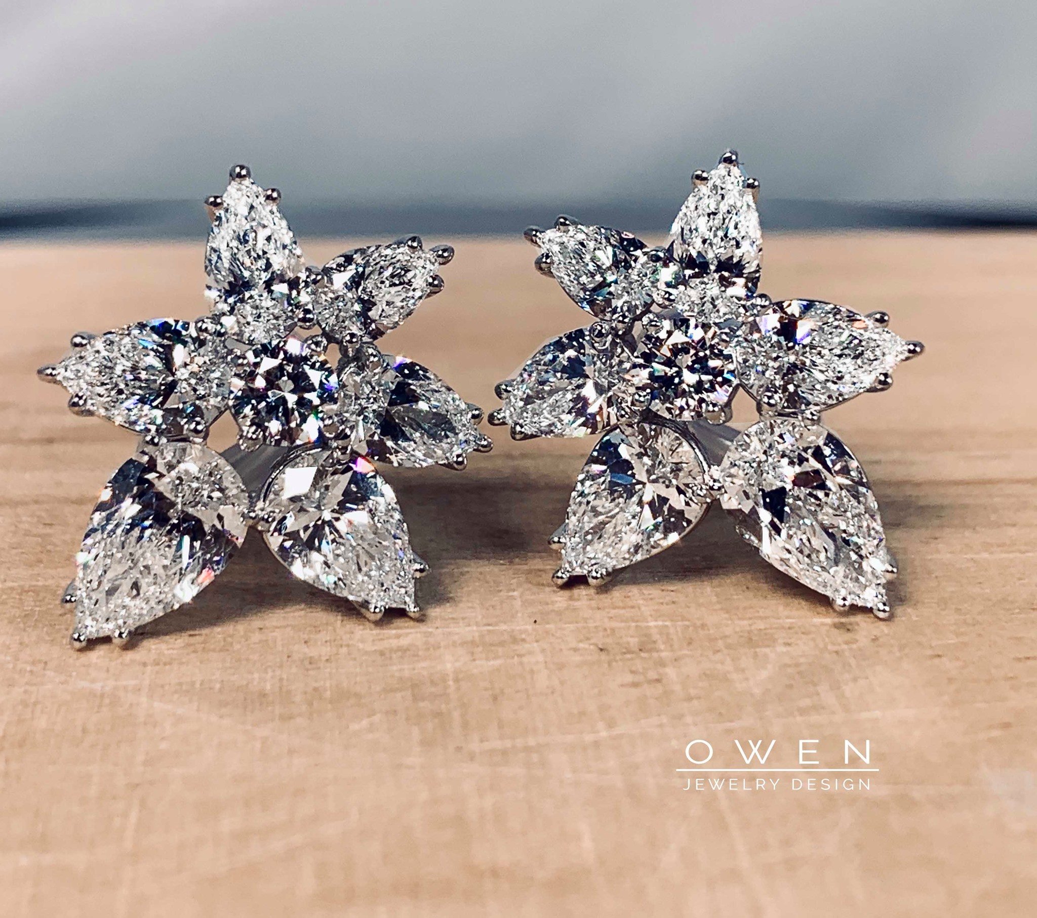 CUSTOM PLATINUMEARRINGS WITH ROUND AND PEAR SHAPED DIAMONDS.jpg
