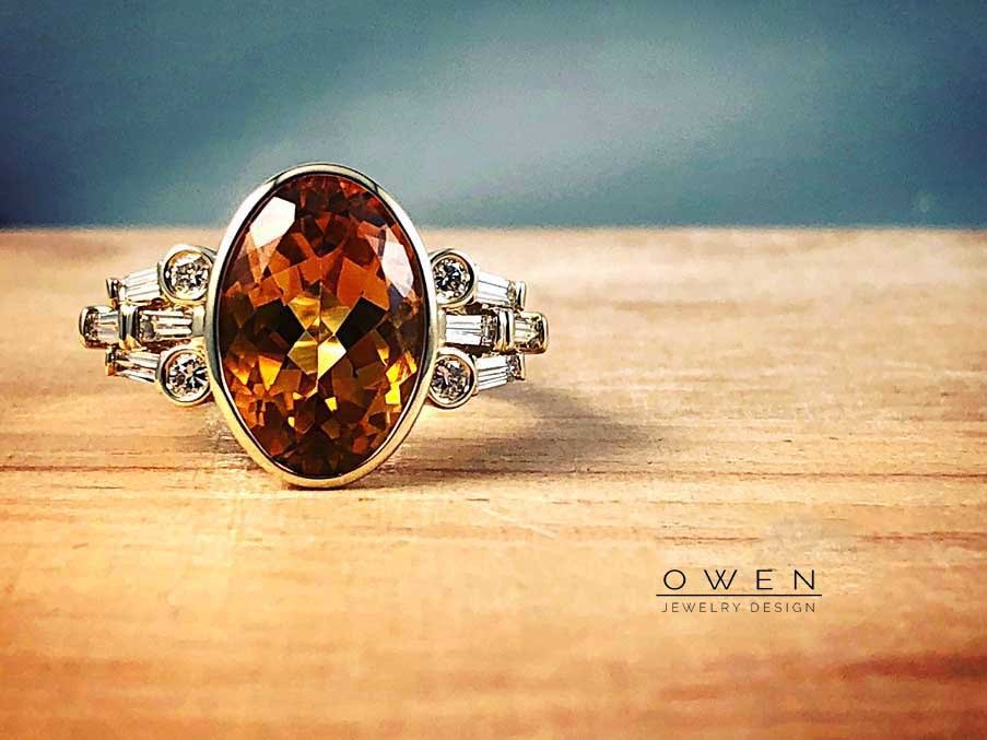 CUSTOM YELLOW GOLD RING WITH A OVAL CUT BRAZILIAN CITRINE, ROUND BRILLIANT CUT DIAMONDS, AND BAGUETTE DIAMONDS.jpg