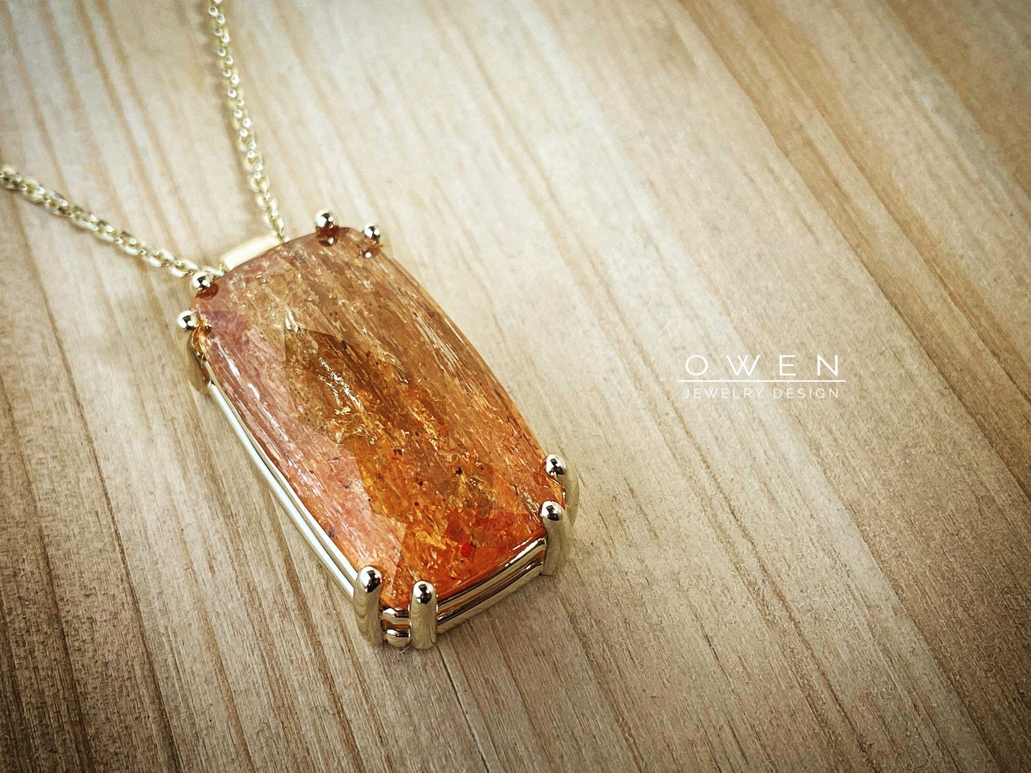 CUSTOM YELLOW GOLD PENDANT CONTAINING AN IMPERIAL TOPAZ WITH VISIBLE INCLUSIONS.jpg