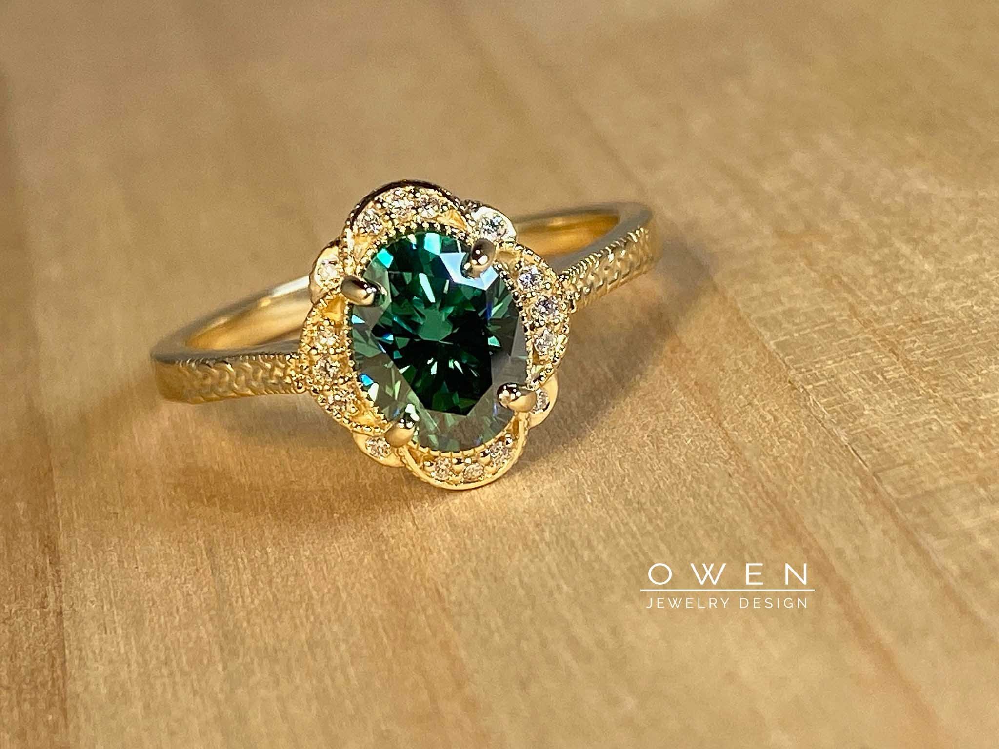 CUSTOM YELLOW GOLD RING WITH A GREEN MOISSANITE AND ROUND CUT ACCENT DIAMONDS.jpg