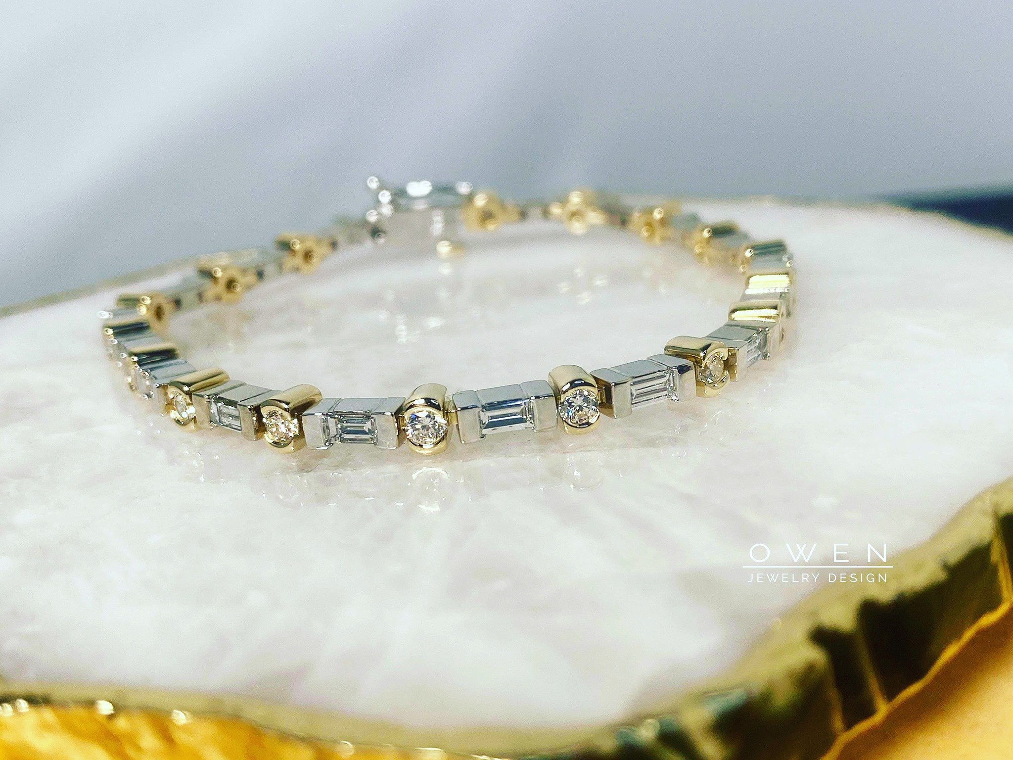 CUSTOM YELLOW AND WHITE GOLD BRACELET WITH ROUND AND STRAIGHT BAUGETTE DIAMONDS.jpg