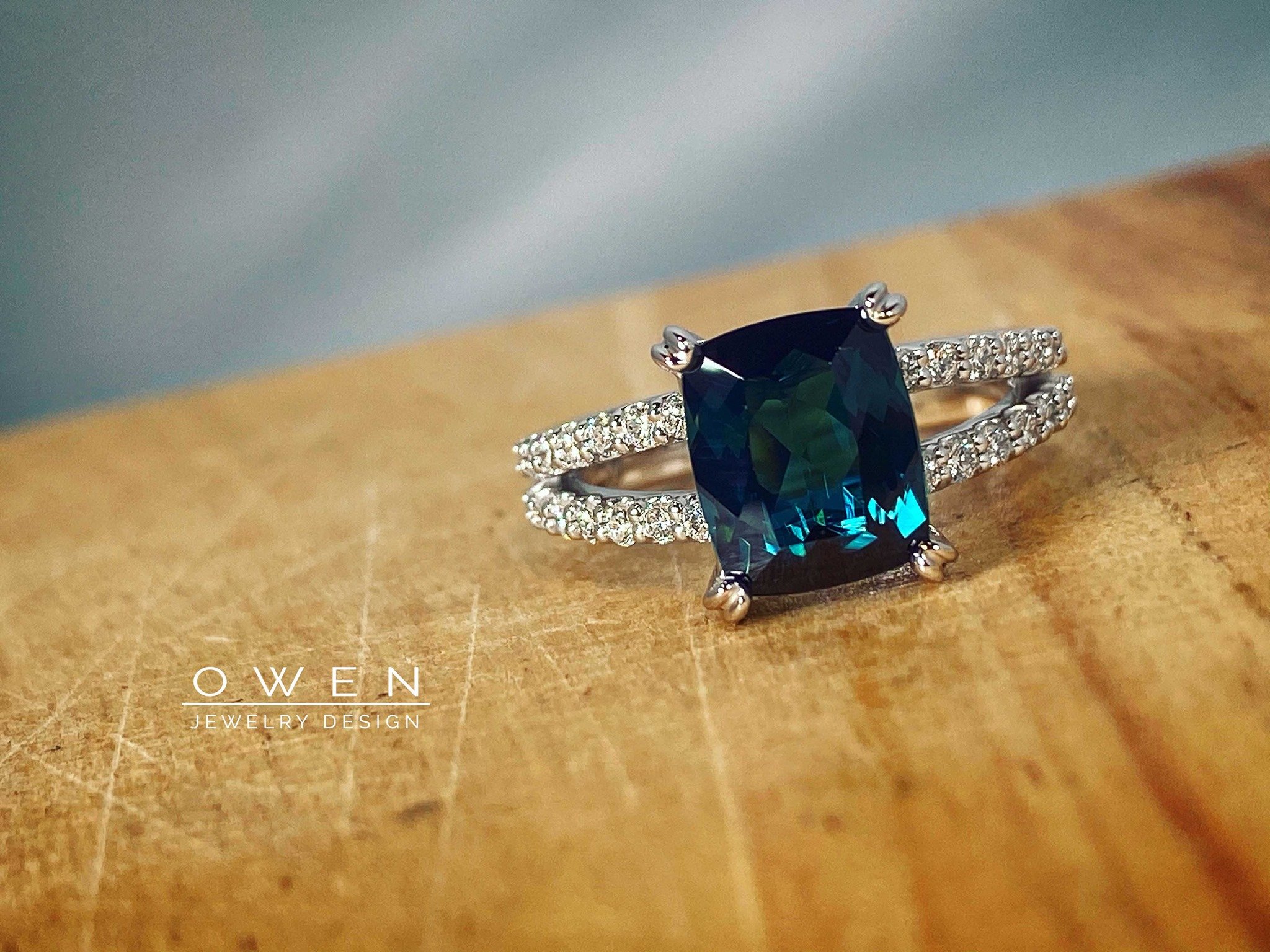 CUSTOM WHITE GOLD RING WITH AN ANTIQUE CUSHION CUT BLUE GREEN TOURMALINE AND ROUND CUT DIAMONDS.jpg