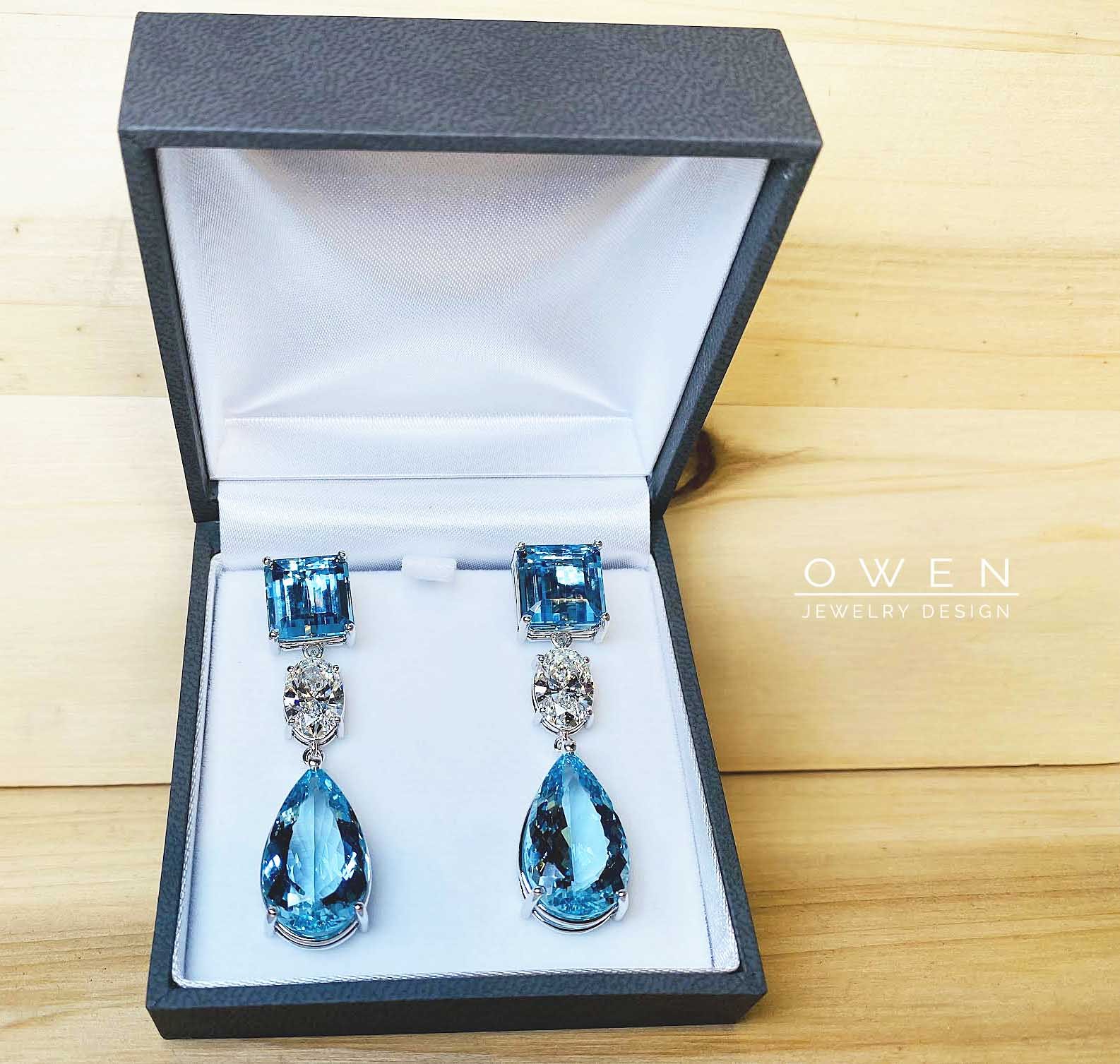 CUSTOM WHITE GOLD EARRINGS CONTAINING RADIANT CUT SANTA MARIA AQUAMARINES, OVAL BRILLINAT CUT DIAMONDS, AND PEAR SHAPED SANTA MARIA AQUAMARINES.jpg