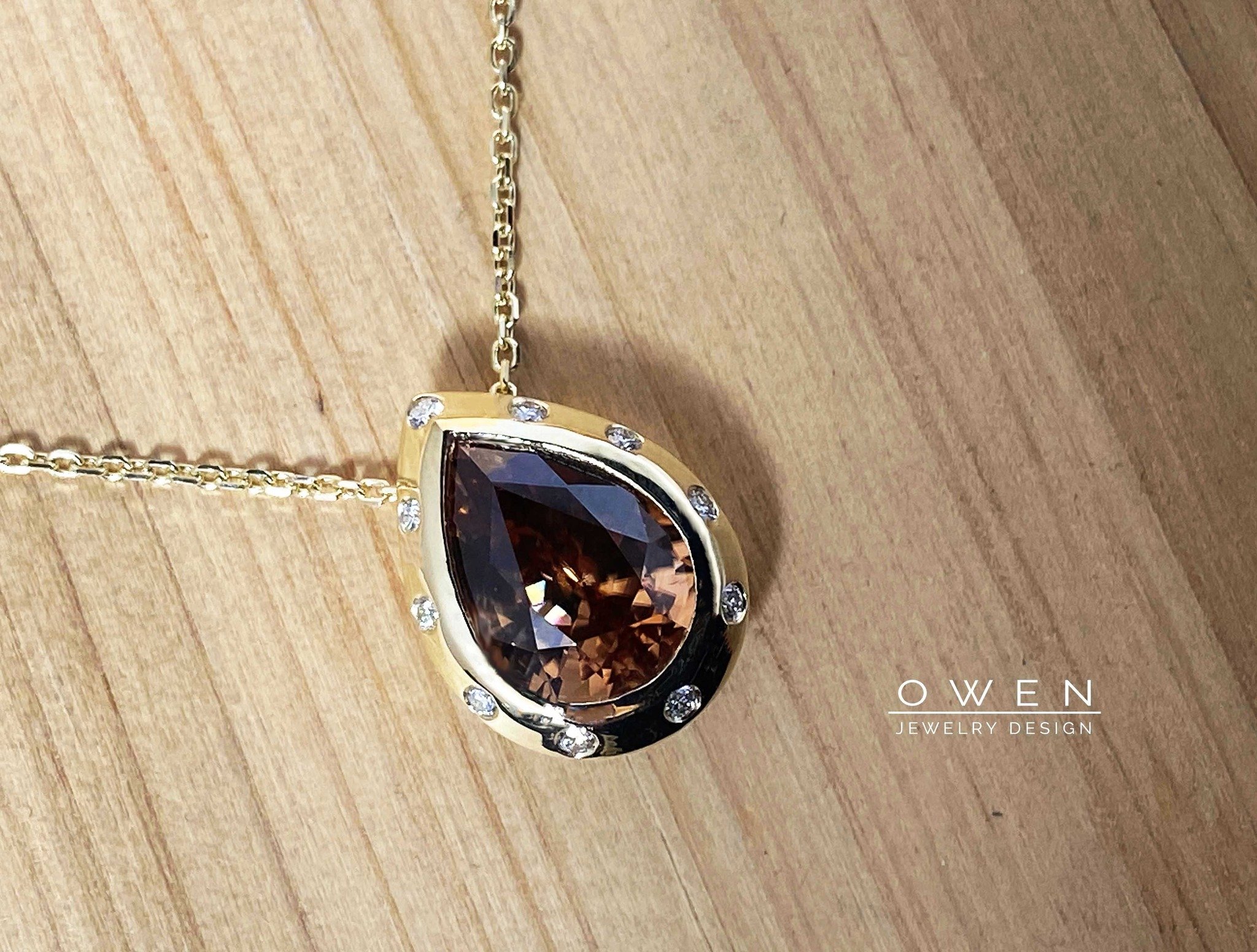 CUSTOM YELLOW GOLD PENDANT WITH A BROWN ZIRCPN AND ROUND BRILLIANT CUT ACCENT DIAMONDS.jpg