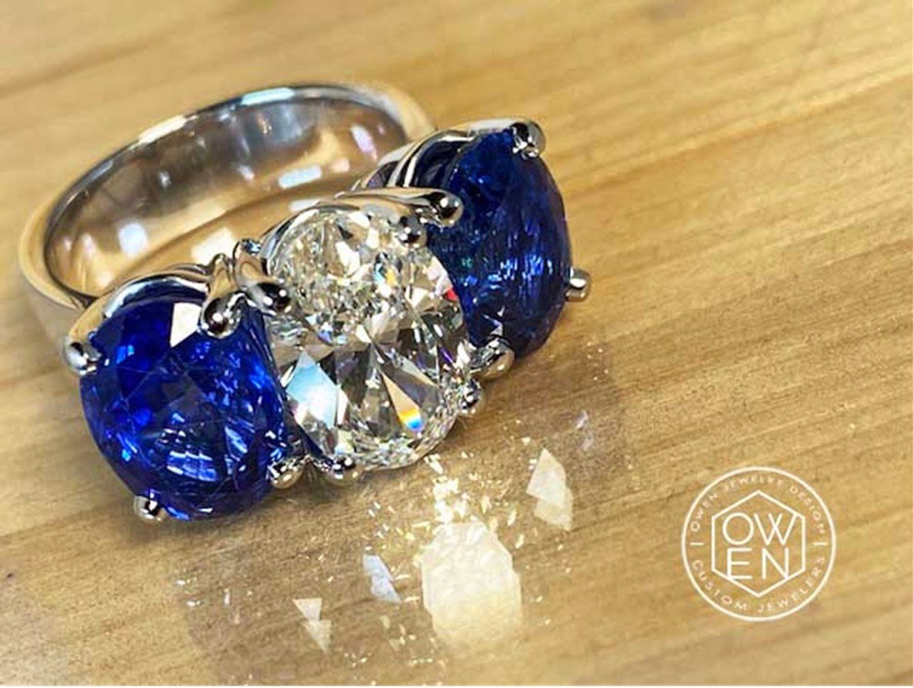 WHITE GOLD RING WITH AN OVAL CAT DIAMOND AND TWO OVAL CUT SAPPHIRES.jpg