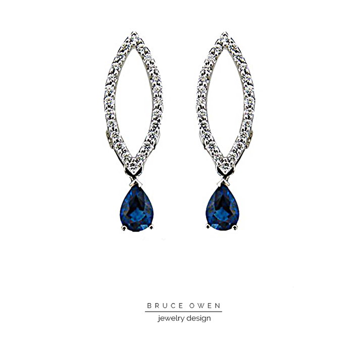 CUSTOM WHITE GOLD EARRINGS WITH A PEAR SHAPED SAPPHIRE AND ROUND CUT DIAMONDS.png