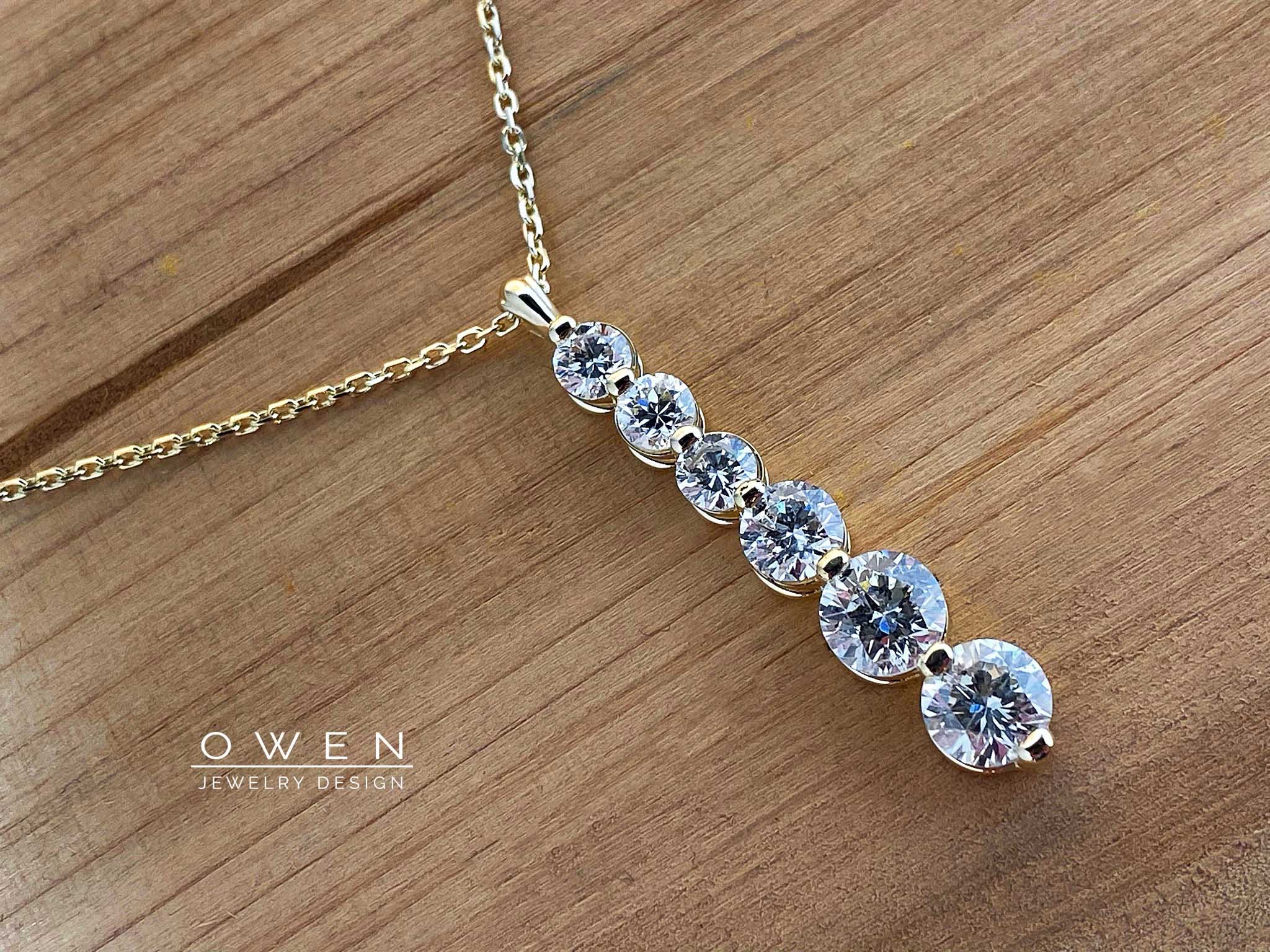 CUSTOM YELLOW GOLD PENDANT CONTAINING 6 ROUND BRILLIANT CUT DIAMONDS.jpg
