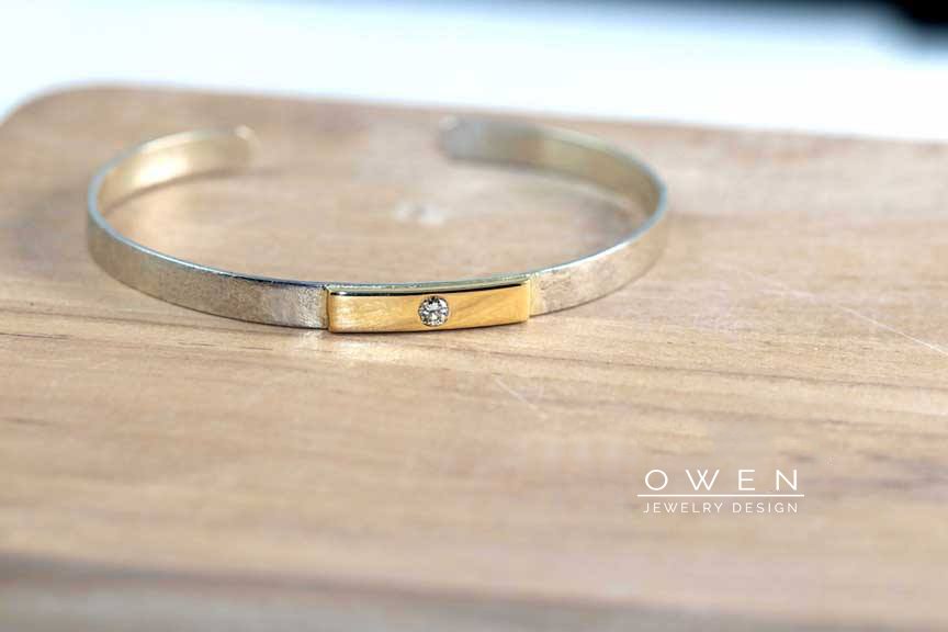 CUSTOM STERLING SILVER AND YELLOW GOLD CUFF WITH A ROUND BRILLIANT CUT DIAMOND.jpg