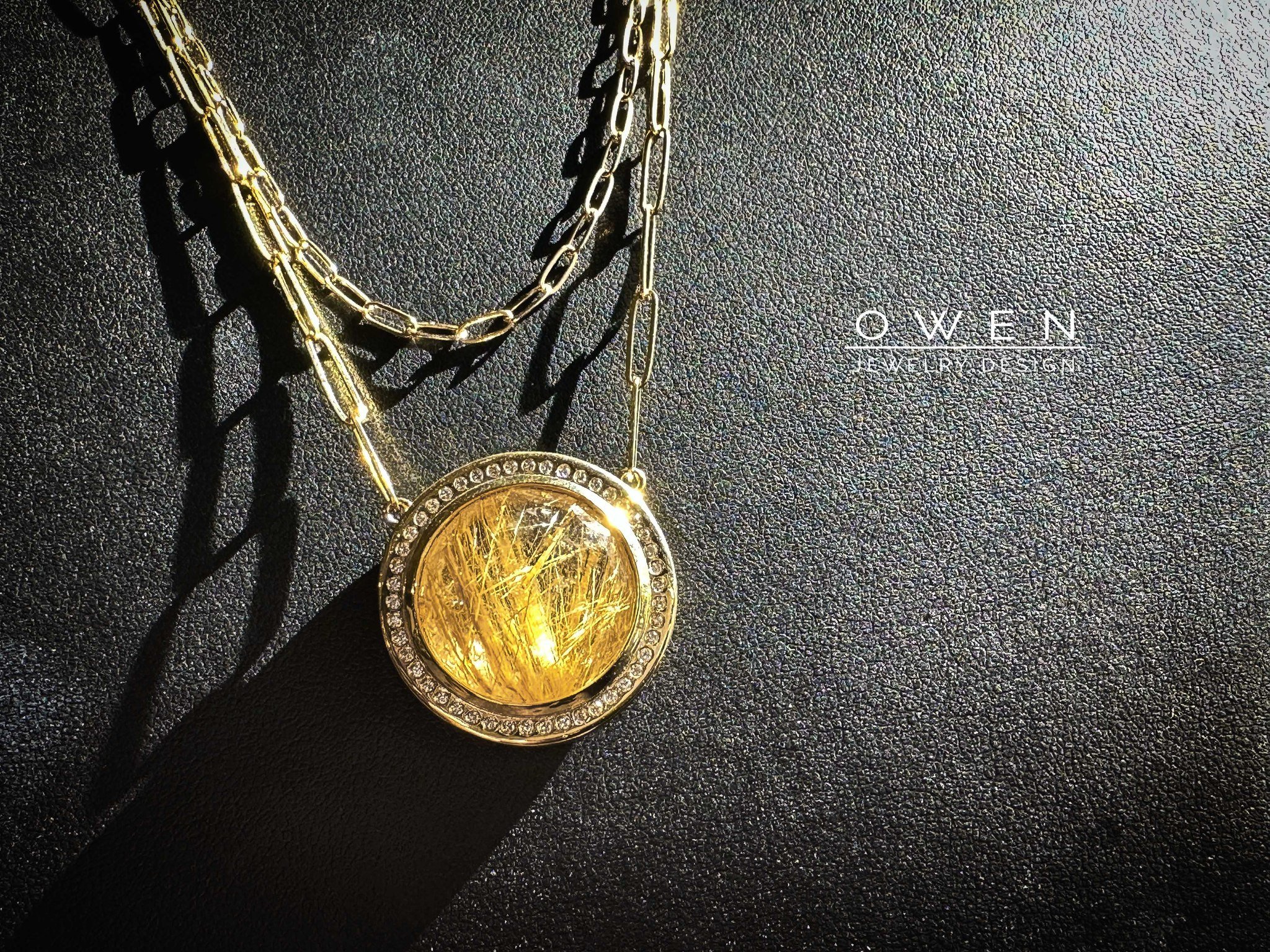 CUSTOM YELLOW GOLD PENDANT WITH A RUTILATED QUARTZ AND ROUND BRILLIANT CUT DIAMONDS ON A PAPER CLIP CHAIN.jpg