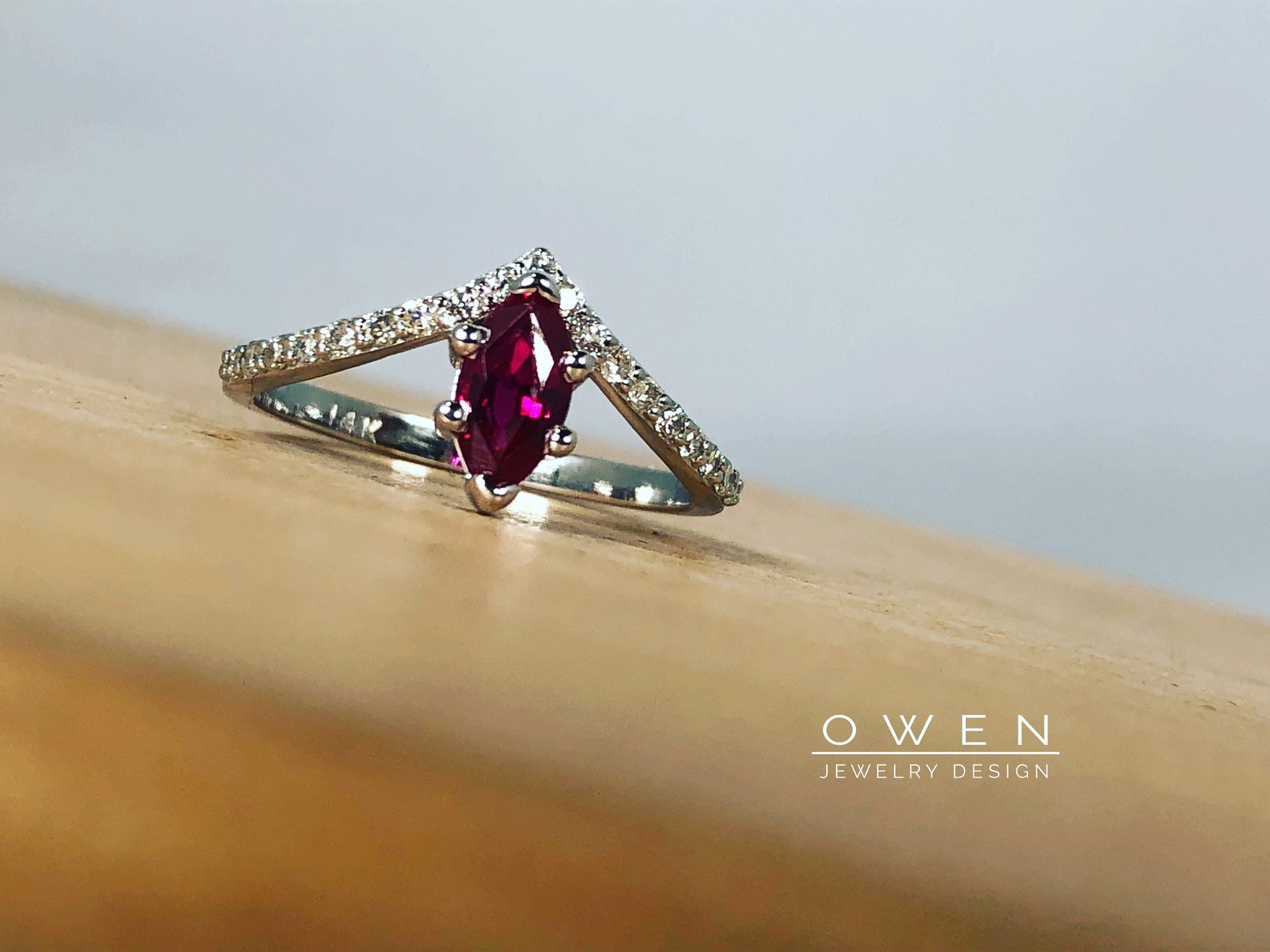 CUSTOM WHITE GOLD RING WITH A MARQUISE RUBY AND ROUND DIAMONDS.jpg