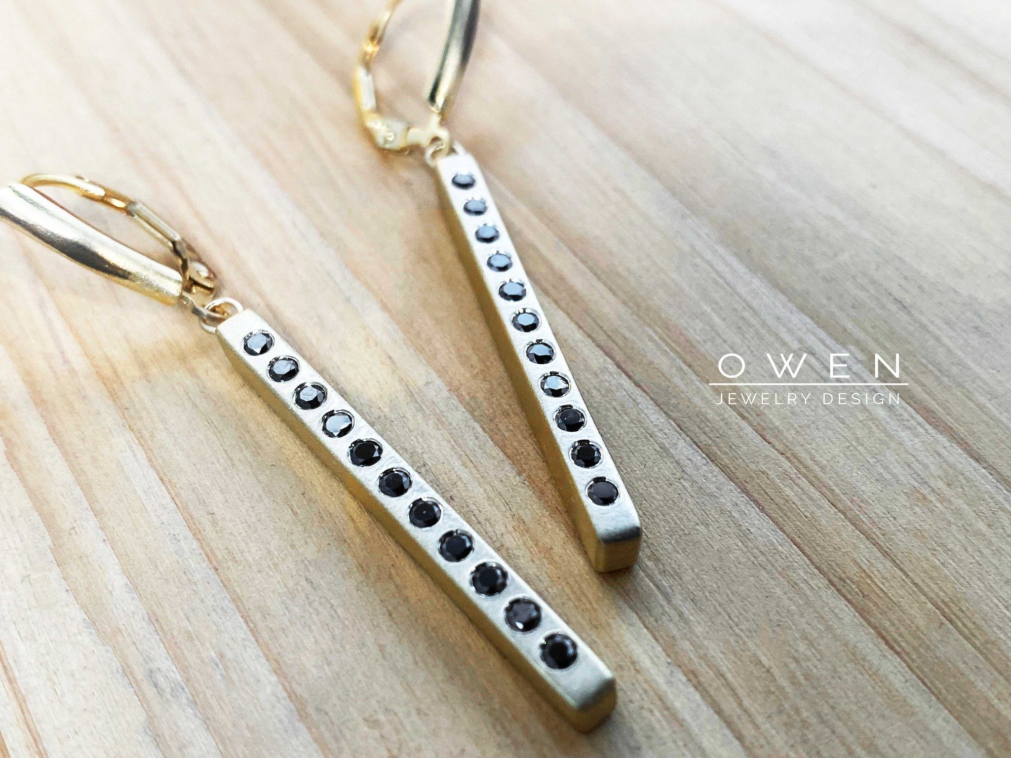 CUSTOM YELLOW GOLD EARRINGS CONTAINING ROUND BRILLIANT CUT BLACK DIAMONDS WITH LEVER BACKS.jpg