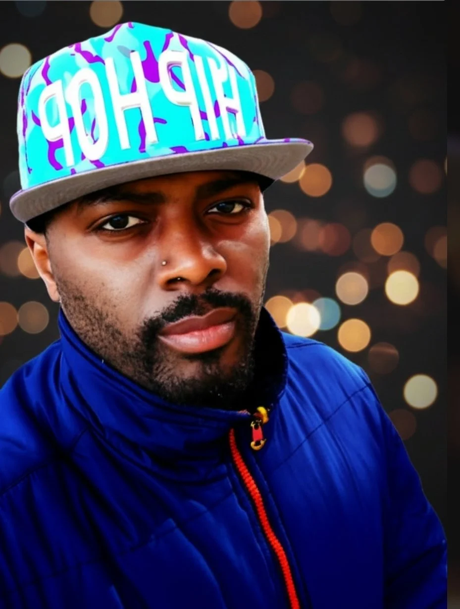 A young man wearing a colorful baseball cap with the word 'HIGH' on it, a blue jacket, standing outdoors with a blurred natural background.