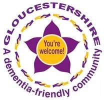 Gloucestershire Dementia-Friendly Community logo with a purple flower, yellow circle saying 'You're welcome!', and surrounding purple text.